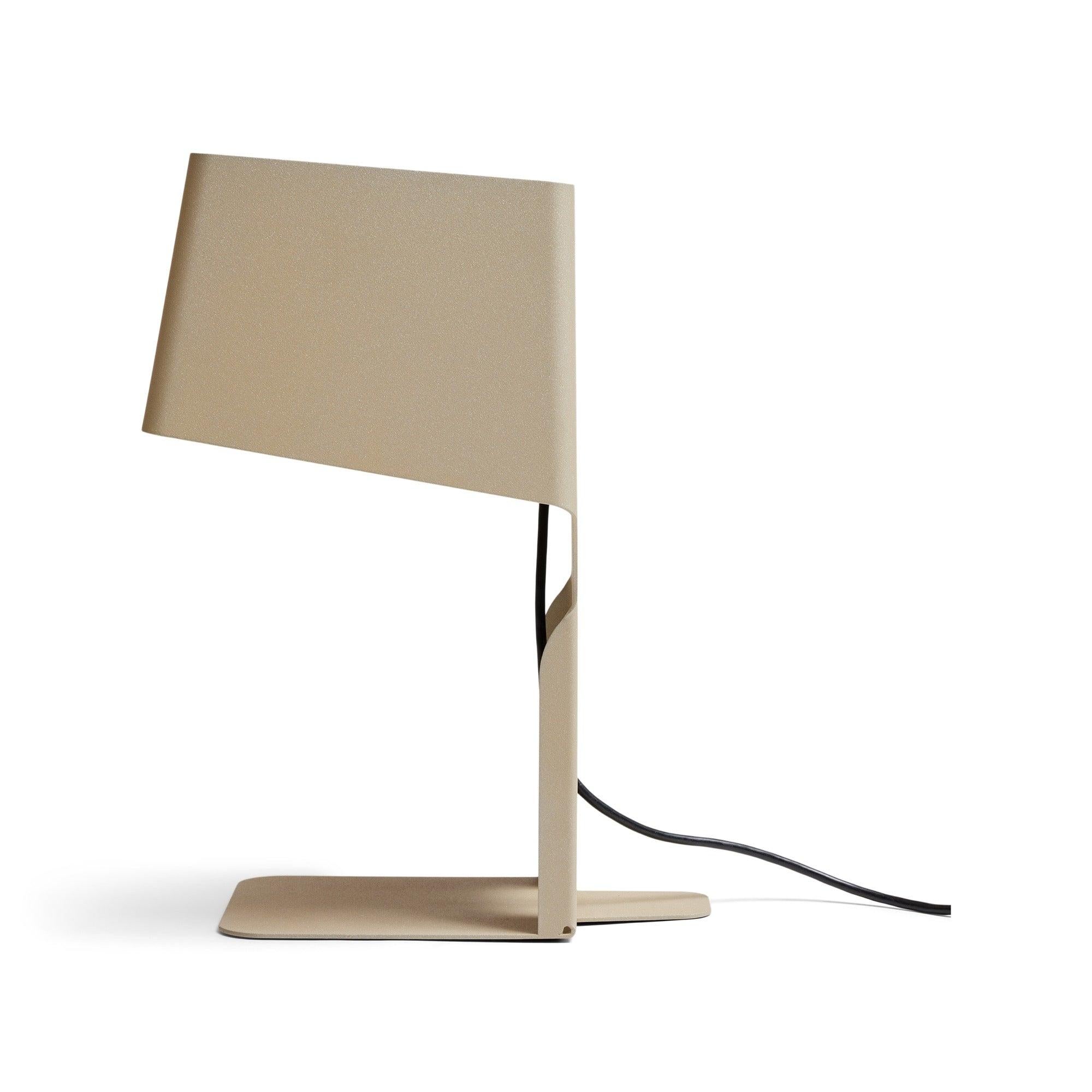 A functional table lamp to be used as a bookend or document stand, formed from a single piece of bent lacquered metal.
