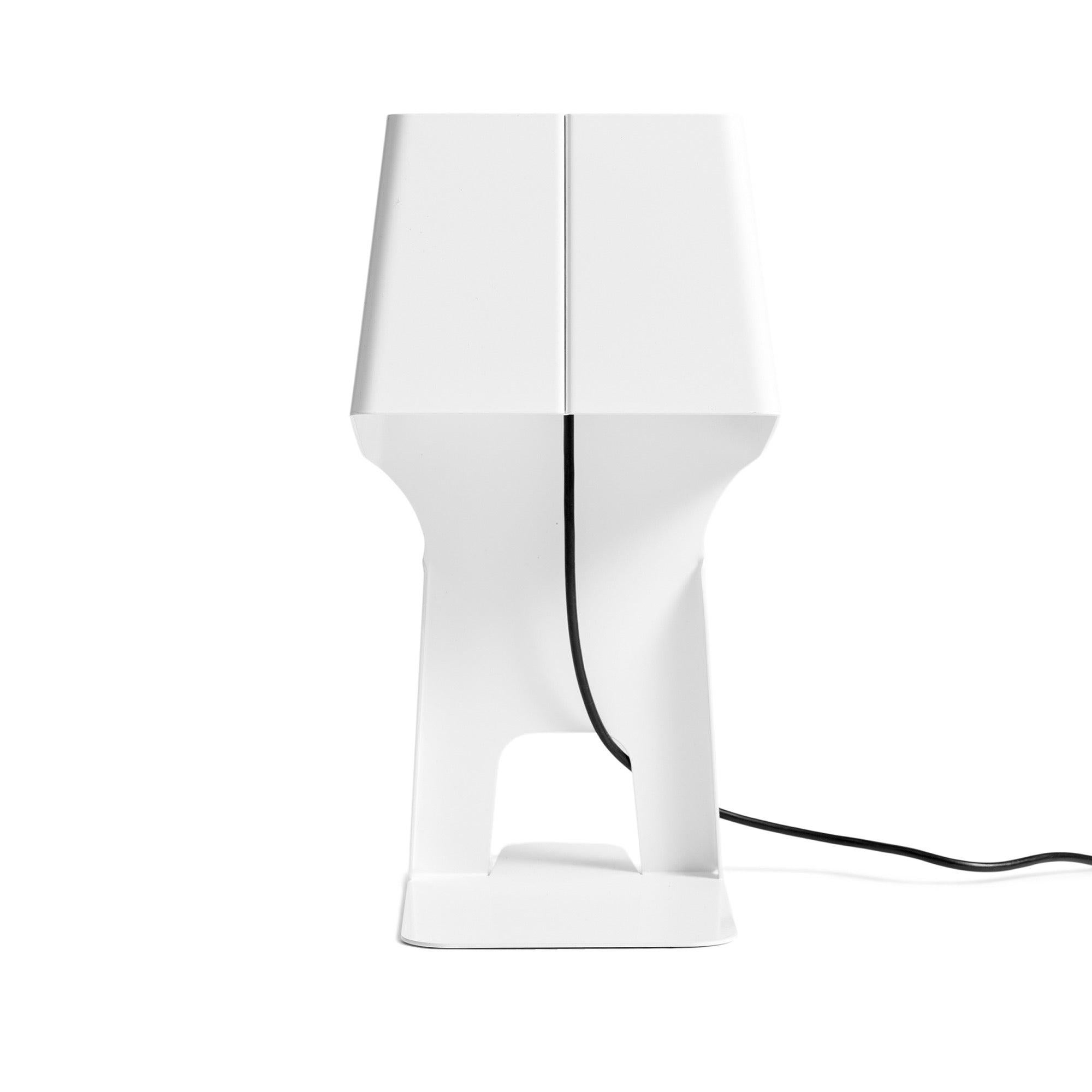 A functional table lamp to be used as a bookend or document stand, formed from a single piece of bent lacquered metal.