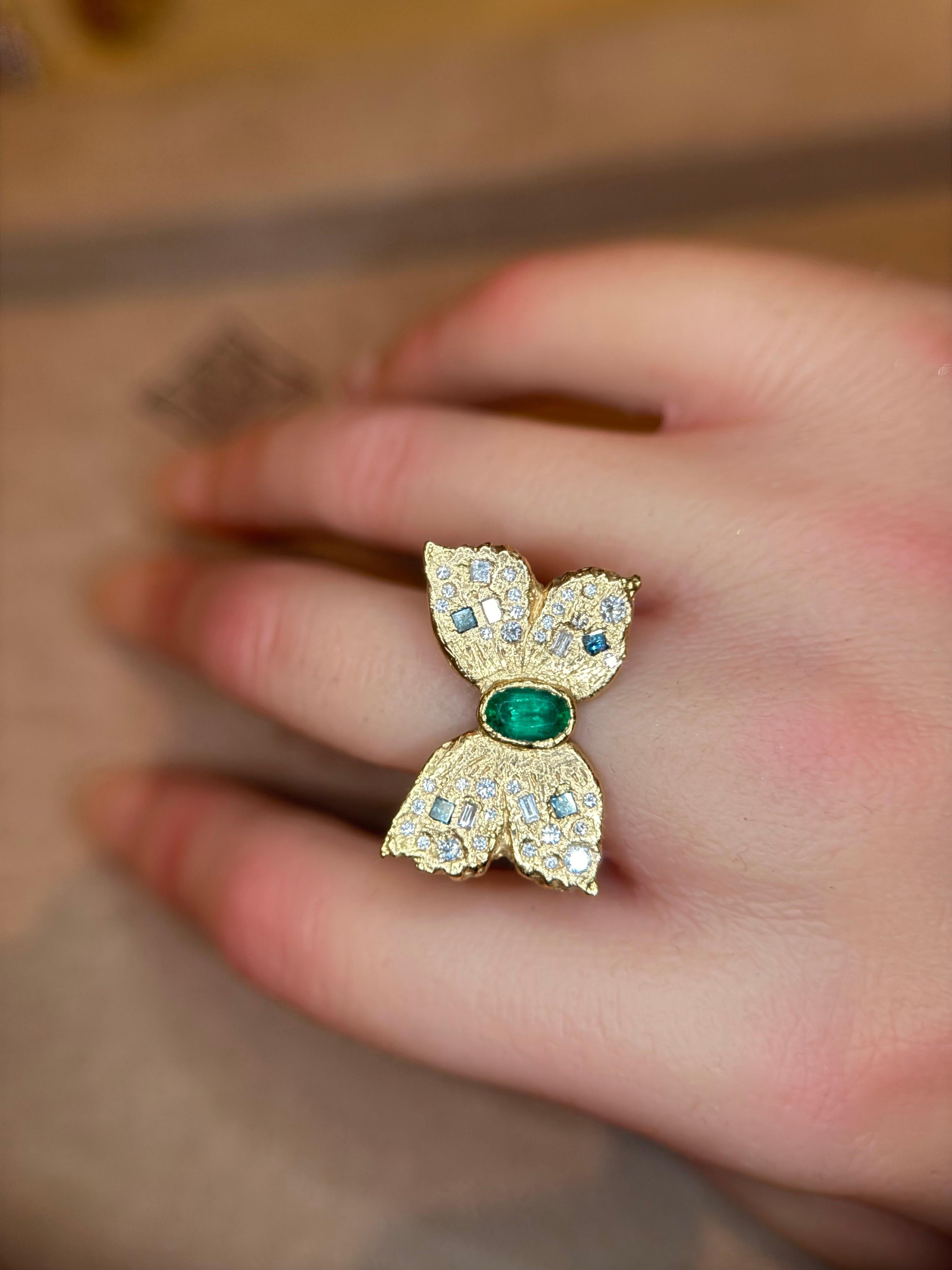 Introducing our exquisite Emerald Butterfly Cocktail Ring, a breathtaking piece that captures the essence of nature's beauty and elegance. Crafted in recycled 18 ct gold, this ring features a stunning butterfly design having a beautiful handpicked