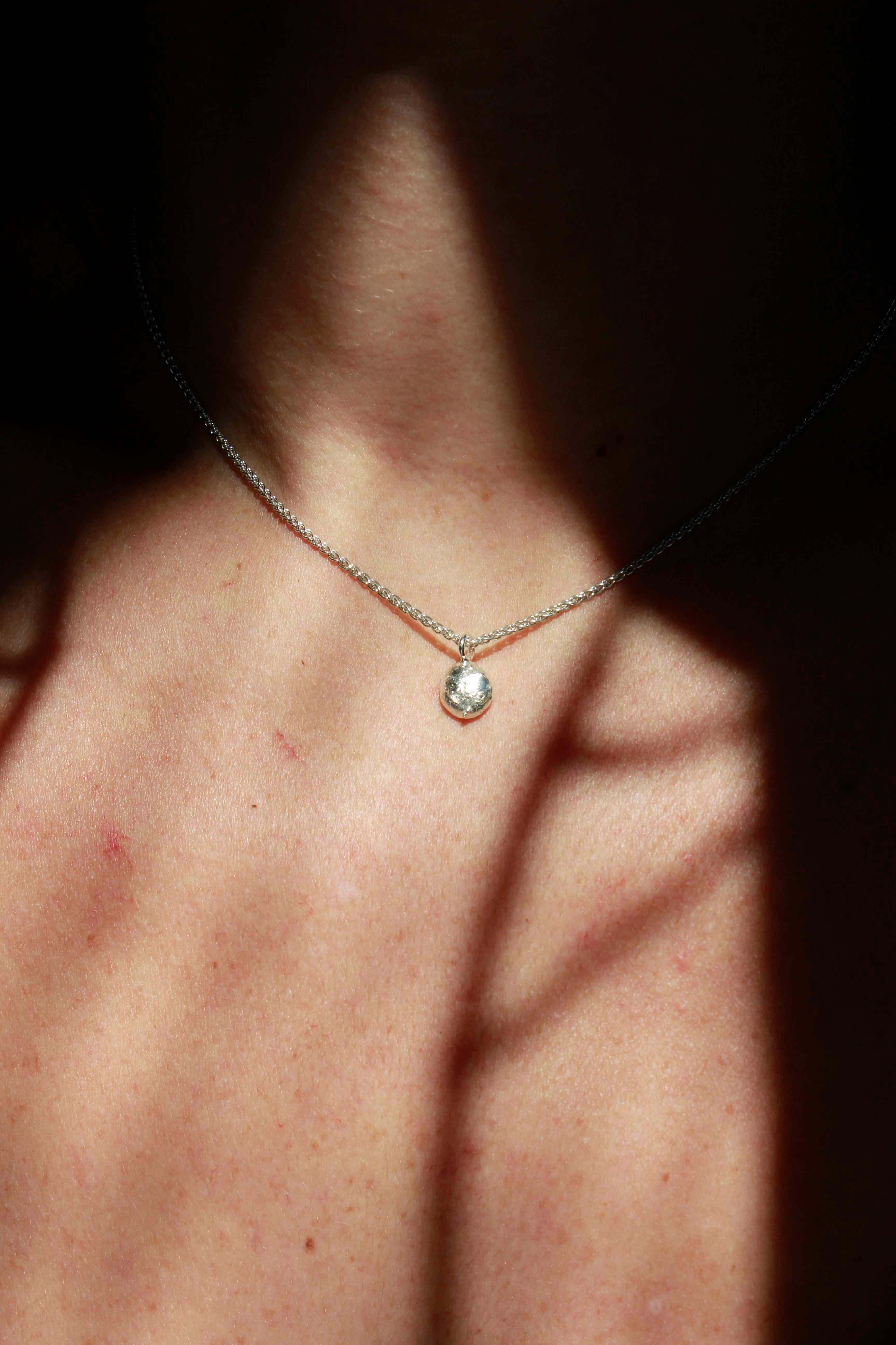 Leto Necklace features a silver ball.

The necklace has 39cm length.

The small organic ball is made from our silver scrap, which means it is 100% recycled and solid.

The ball has approximately 0.8cm width and 0.5cm length.

Please note that this
