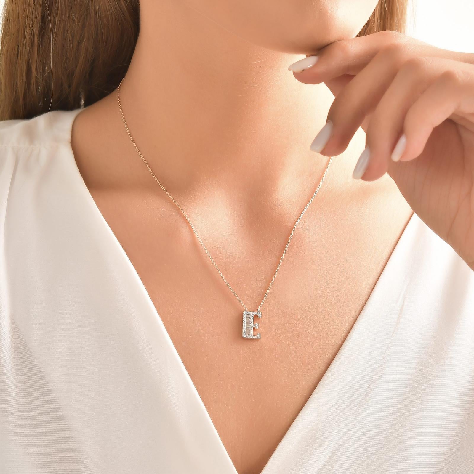 This Beautiful Baguette Diamond Letter Pendant Is Entirely Handcrafted In 14 Karat White Gold. 
The Letter E Pendant Is Garlanded With Channel-Set Baguette-Cut Diamonds And Prong Set Brilliant Round Diamonds Weighing 0.43 Carats. All Of The Stones