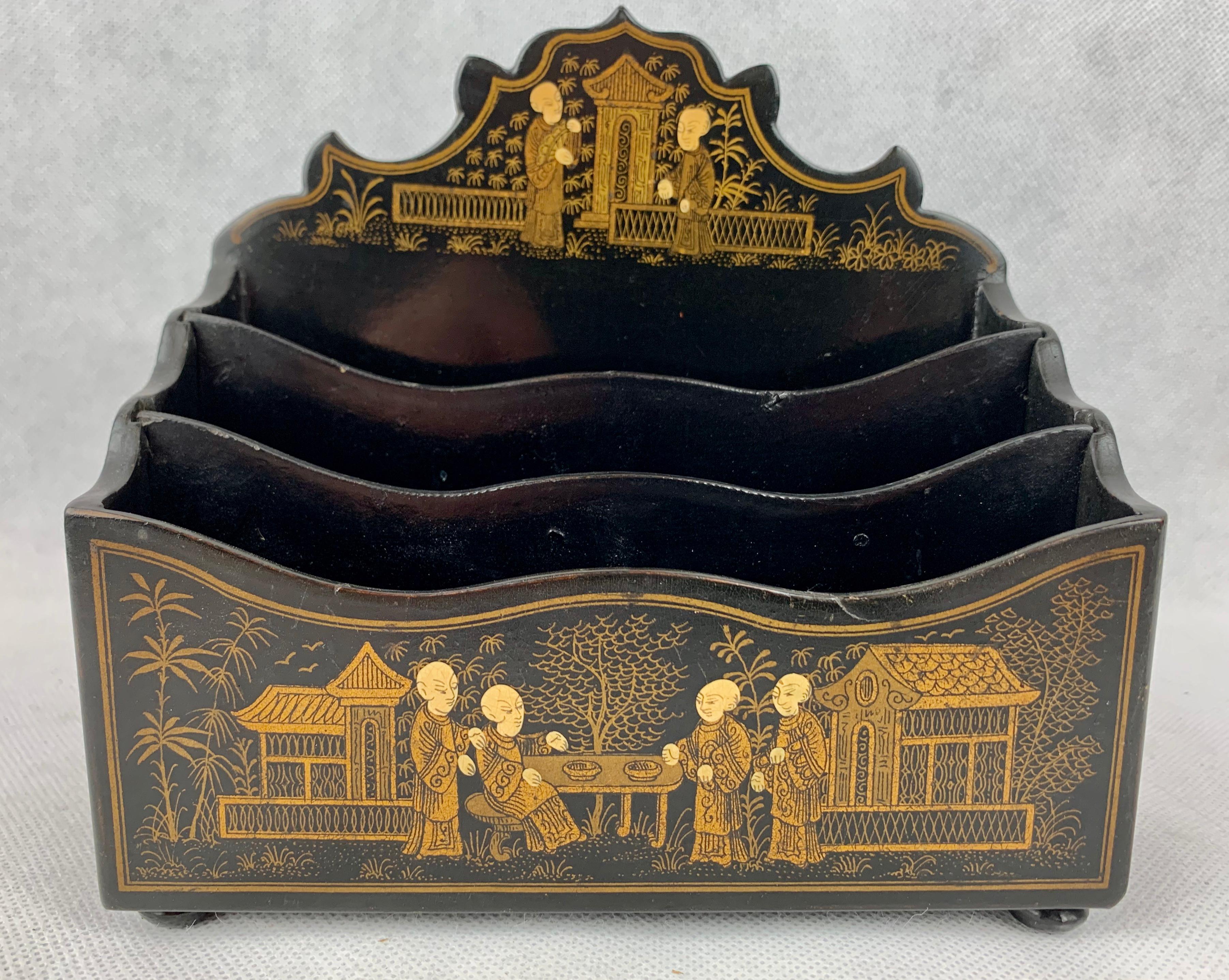 Antique letter holder of black lacquered papier mâché. There are two removable dividers for organizational purposes. The letter holder sits on four squashed bun feet. The gilt designs are hand painted. This piece is in very sturdy condition and very