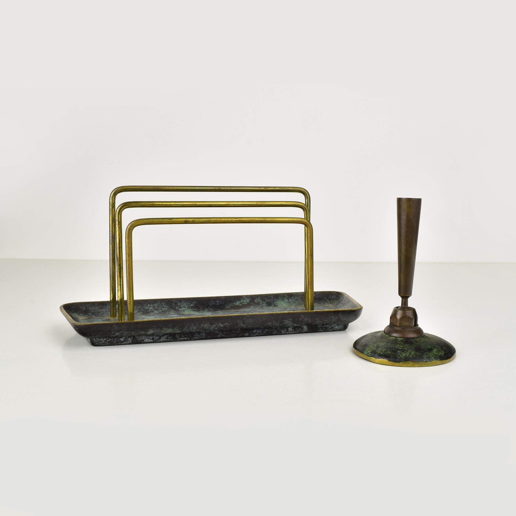 This exquisite Art Deco and Bauhaus-style set features a letter holder and a pencil holder, both meticulously crafted from verdigris patinated bronze or brass.

The letter holder boasts a sleek, elongated base with three elegantly curved brass rods
