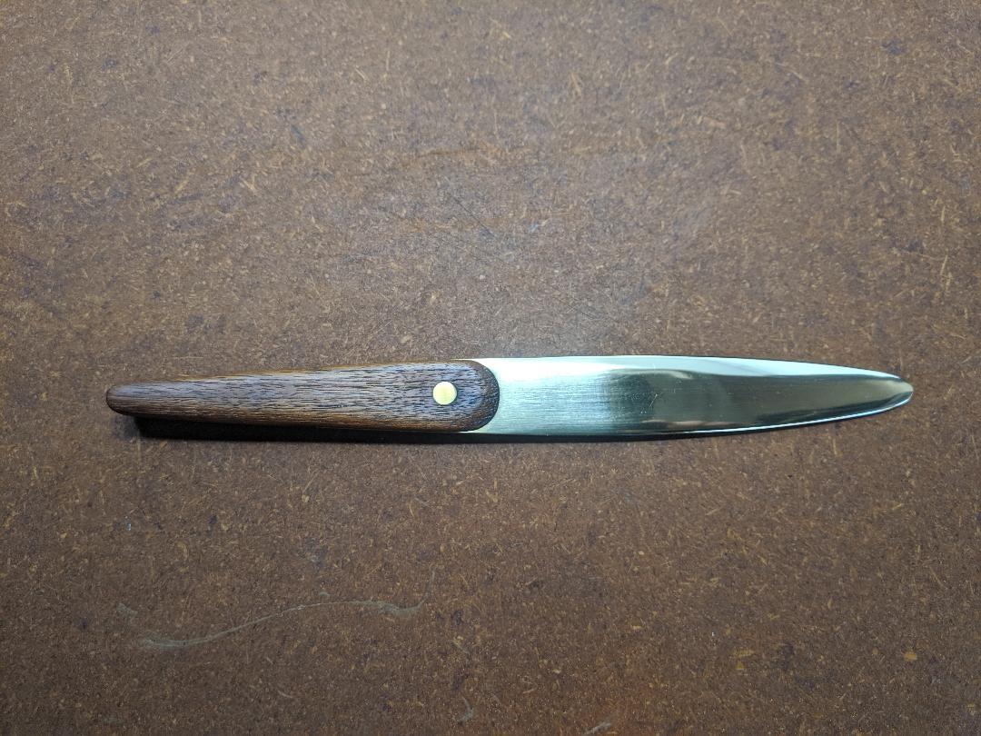 Letter opener in teak and brass, designed by Jens Quistgaard, and produced by Dansk. Measures: 10 1/4” long and 1