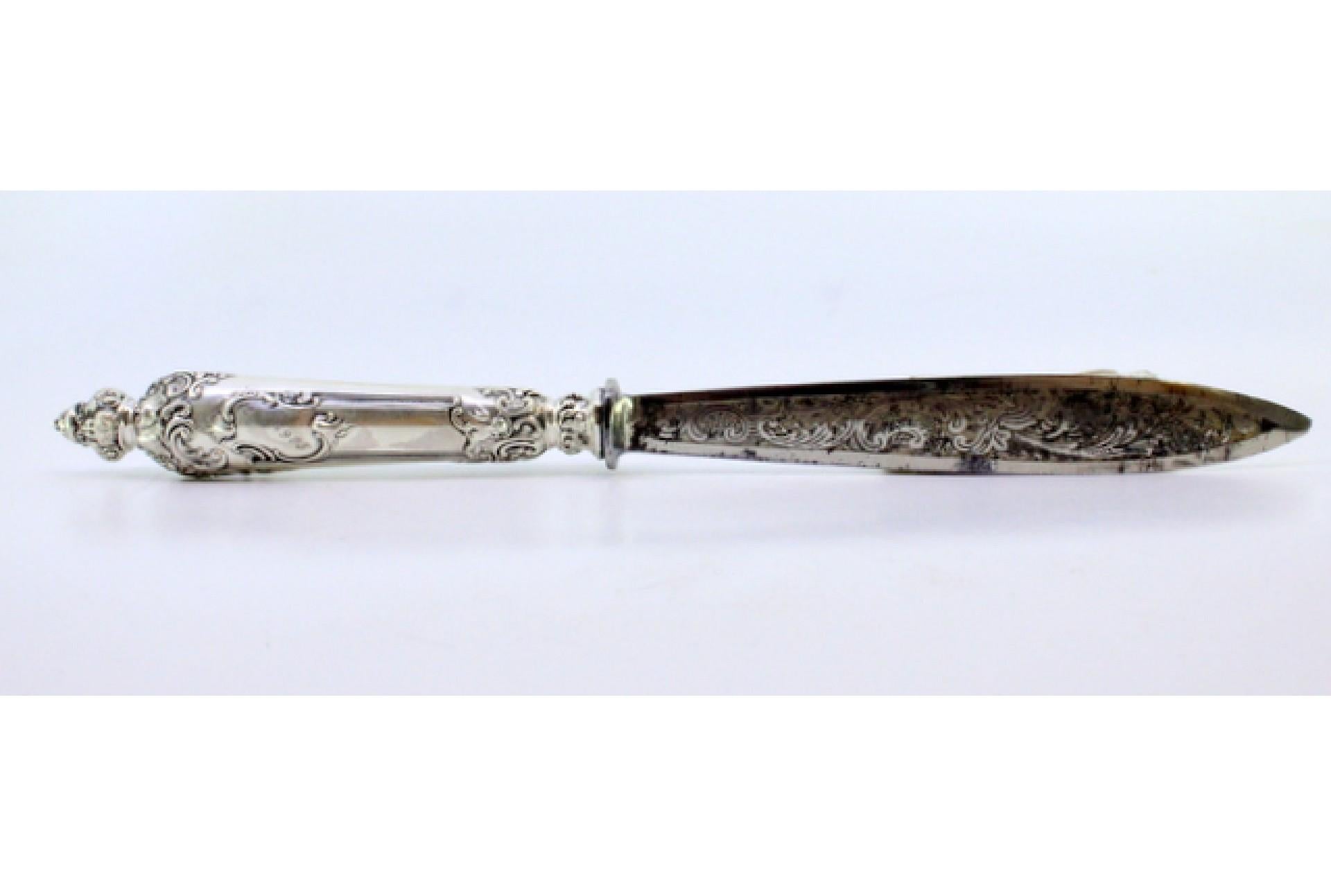 Metal Letter opener in the shape of a knife with an embossed silver handle and large m For Sale