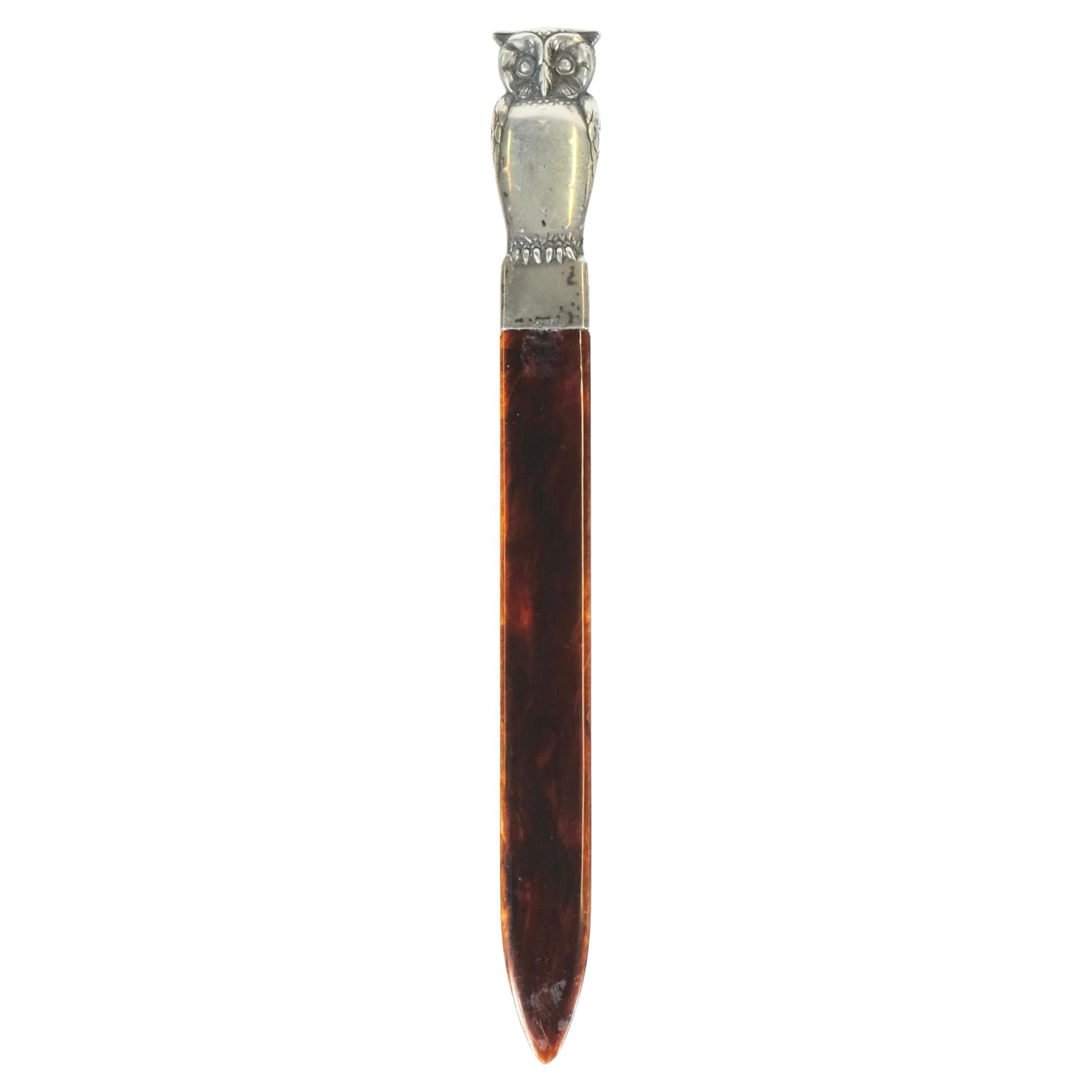 Letter-opener with silver handle in the shape of an owl.