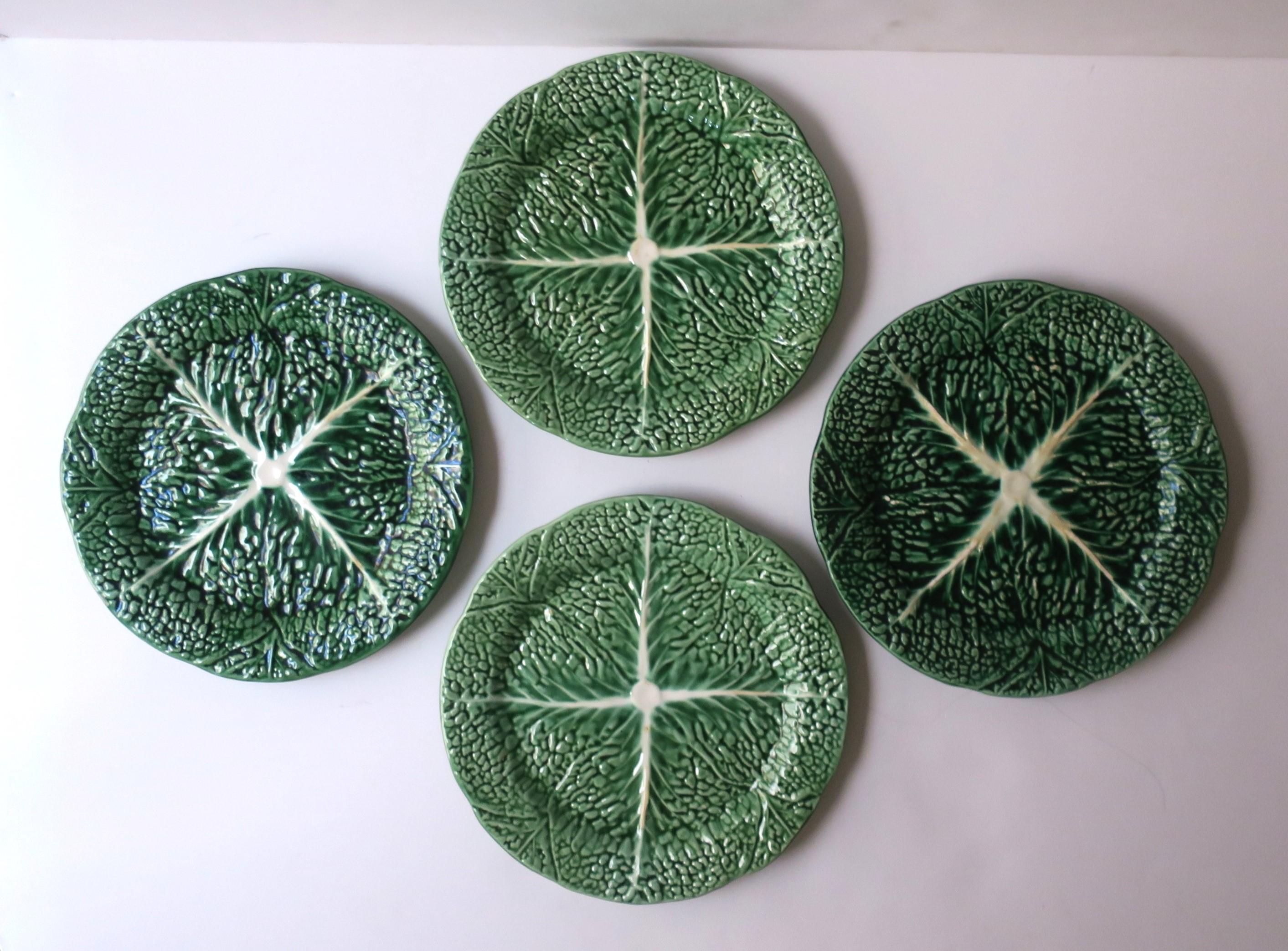 A vintage set of four (4) green and white lettuce or cabbage green leaf plates, Palm Beach style, circa late-20th century, Portugal. A great set for breakfast, lunch, dinner, and more. Set would make a beautiful addition to any dining table, table