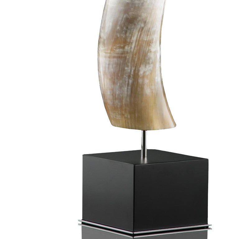 Crafted from natural Corno Italiano, the Leuca sculpture promises to add natural beauty to your home with its organic palette and grain. A modern square base in wood with a glossy black lacquer finish completes the look adding a cleanly elegant