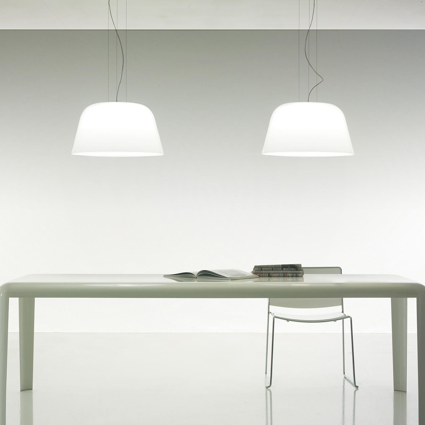 The Ayers pendant is designed with clean lines that create an impact. Designed by MarCo Piva in 2005, its hand blown diffuser is made of multiple layers of glass to create a rich, white look. This traditional Murano hand blown glass technique is
