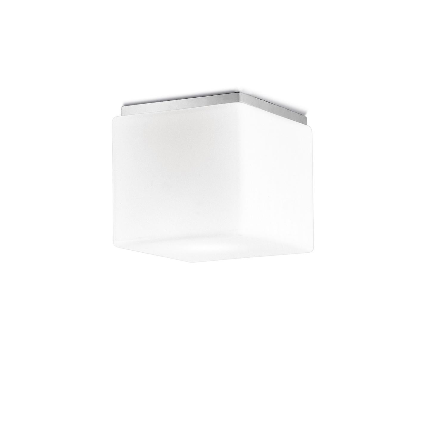 The Cubi Ceiling/Wall Lamp, designed in 2000, is an icon of Leucos. Its cubic form is surprising for handmade glass, which makes it a delightful lamp. Its hand-blown satin white diffuser is made of multiple layers of glass to create a rich, white