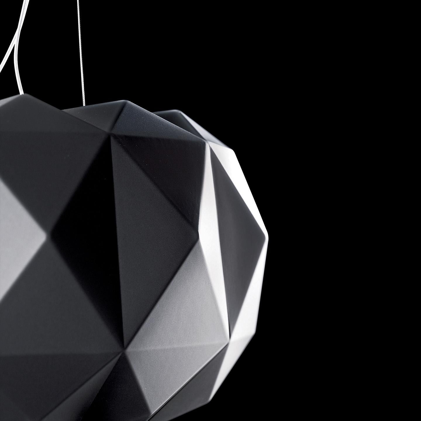 The Deluxe Pendant, designed by Archirivolto, is a versatile and bold lighting collection featuring a geometrically-patterned, cloud-shaped hand-blown glass diffuser. Its hand blown satin white or matte black diffuser is made of multiple layers of