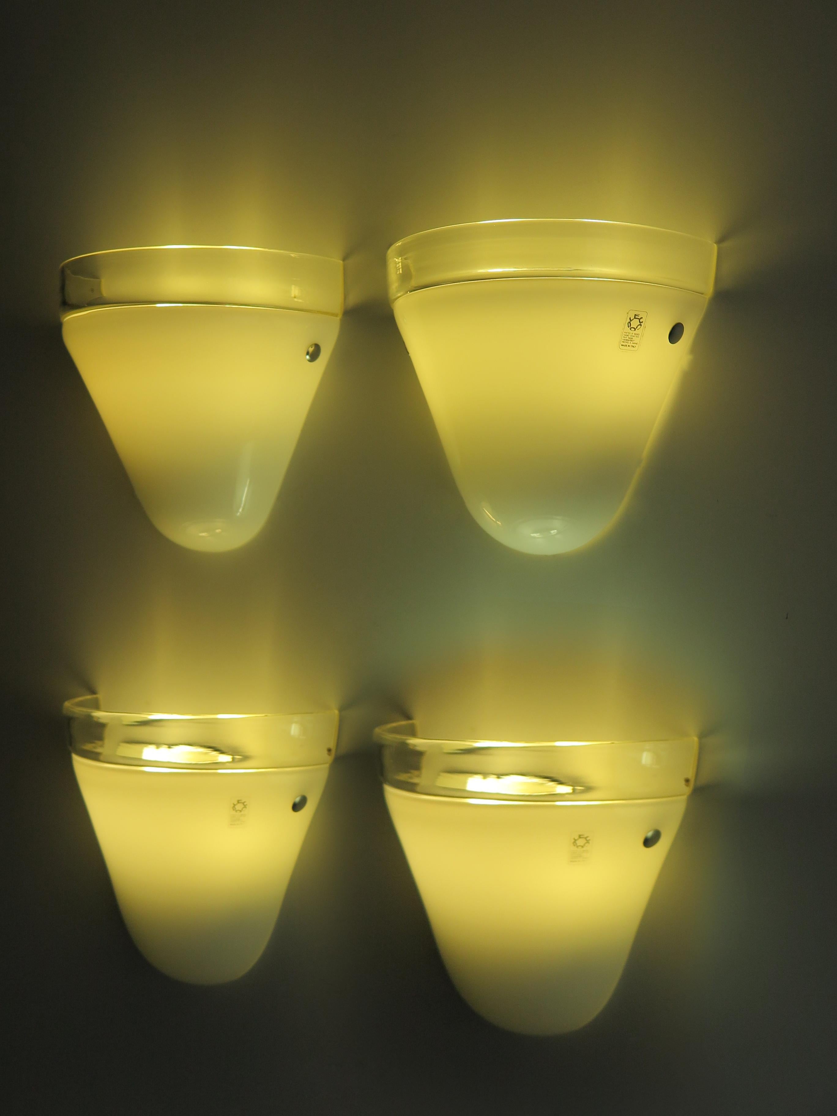 Italian midcentury sconces wall lamps, set of four, produced by Leucos with blown Murano glass diffusers, circa1970s. Manufacturer’s adhesive label on glass.

Please note that the lamps are original of the period and this shows normal signs of age