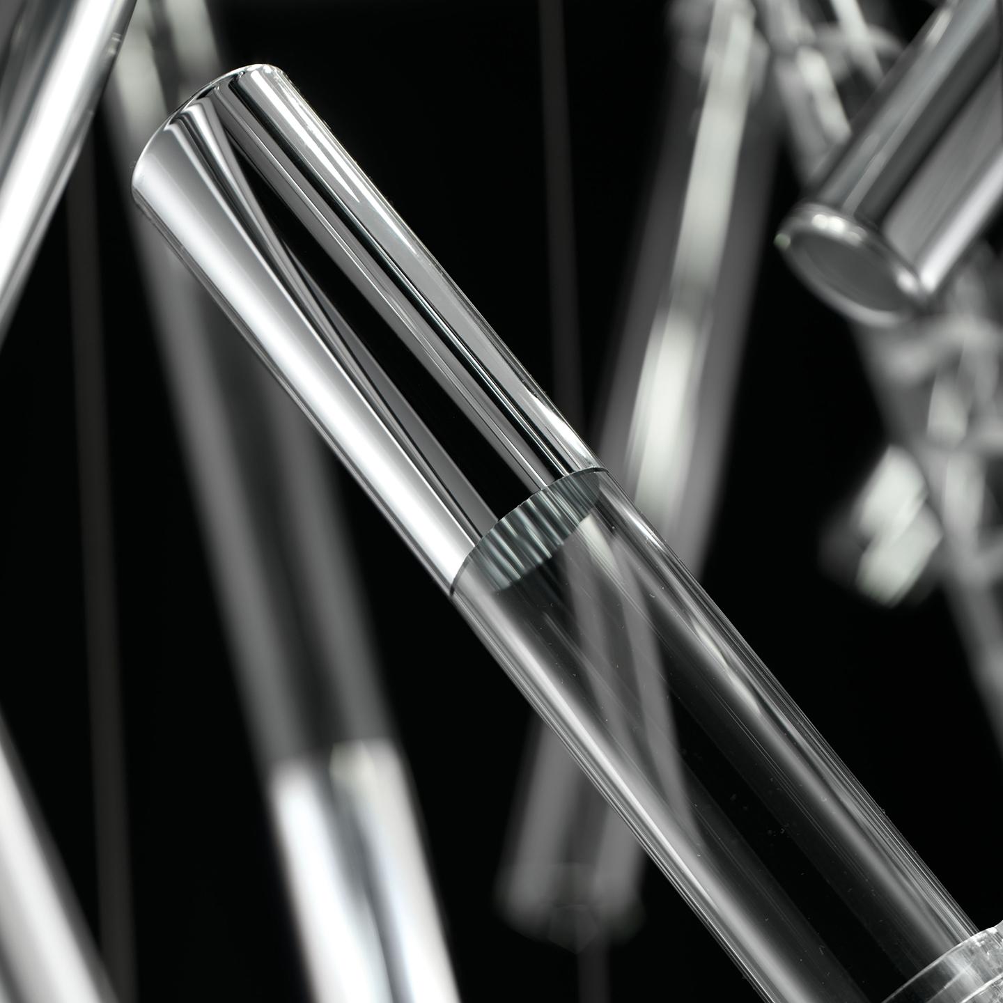 Ixi, designed by Filippo Caprioglio, is a system of beautiful handmade cylindrical glass rods with reflective metal decorations. Each Ixi rod is light, simple and airy—but placed together as a group they create a stunning visual effect that is
