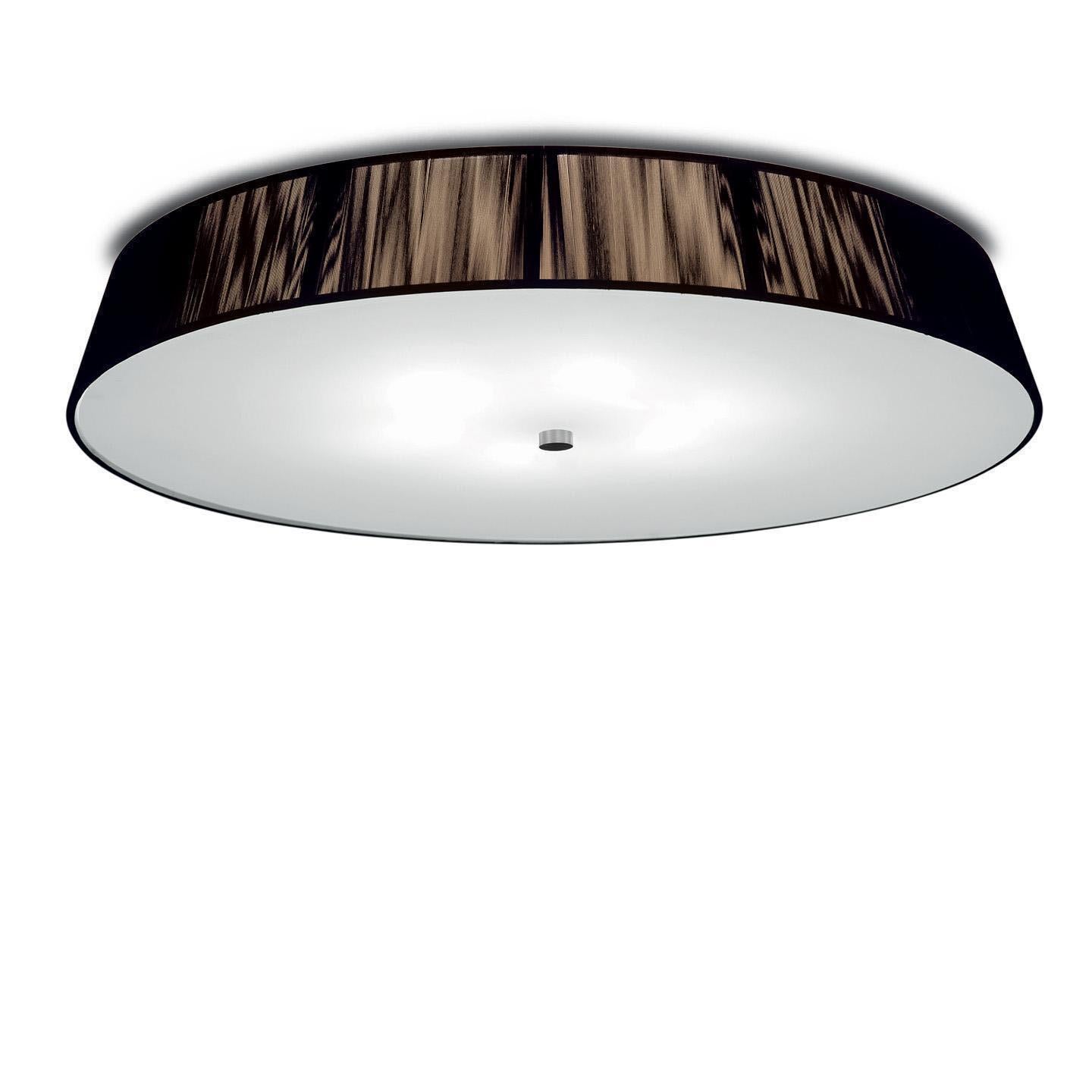 The Lilith ceiling lamp is an elegant lighting solution with a stunning light effect created by threading thin string in a consistent pattern across the shade. As you engage it from different viewpoints, the light pattern shimmers and changes. The