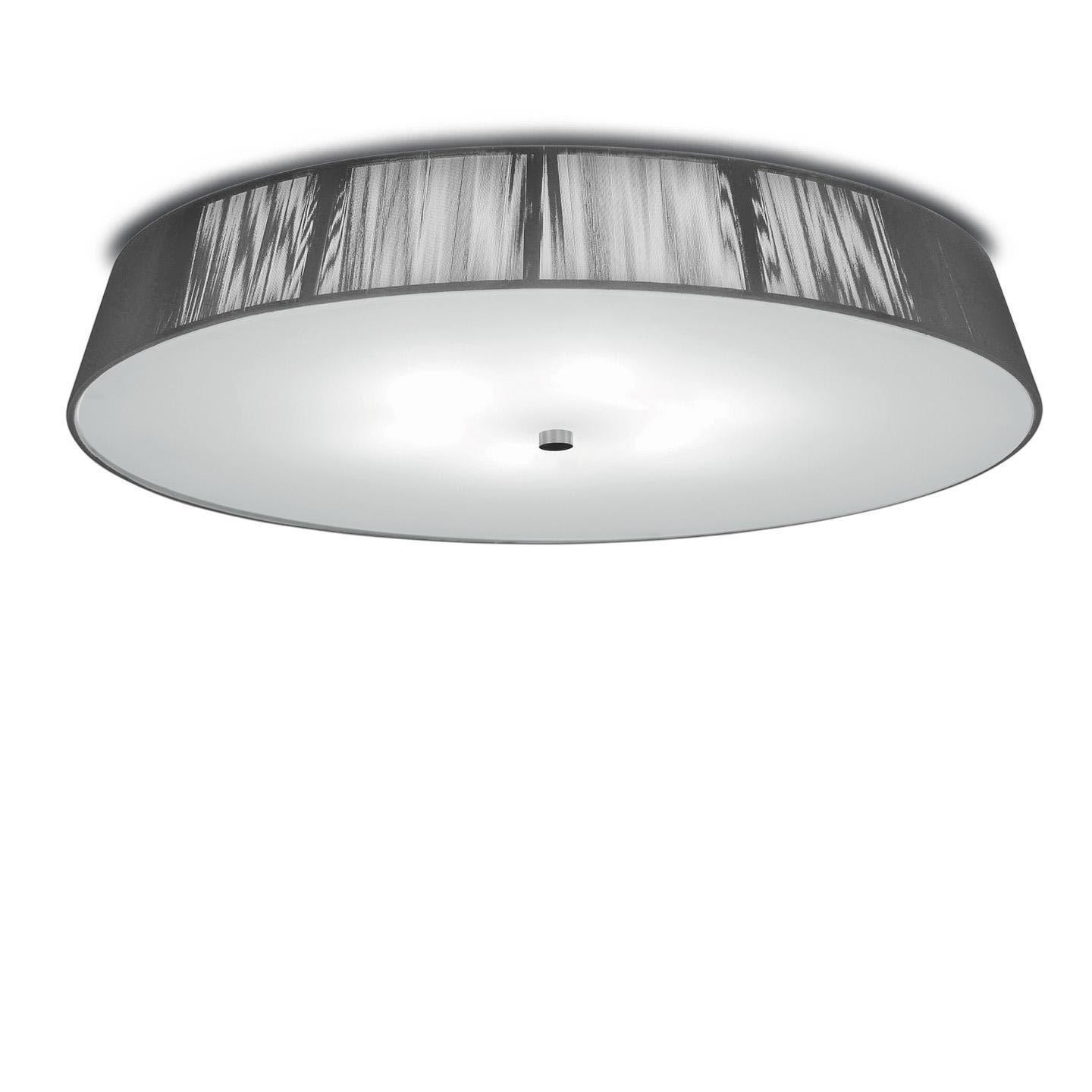 The Lilith ceiling lamp is an elegant lighting solution with a stunning light effect created by threading thin string in a consistent pattern across the shade. As you engage it from different viewpoints, the light pattern shimmers and changes. The