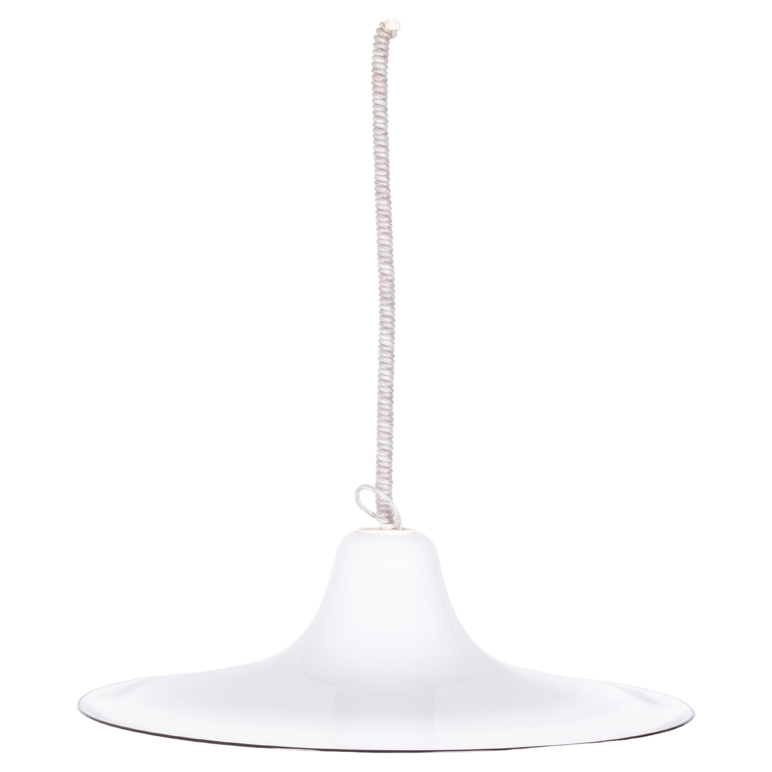 This beathiful pendant lamp was designed by Renato Toso and produced by Leucos in Italy, during the 1970's. It is made of a thick piece of Murano Glass, the color goes from opaline white to transparent.  Original label of the manufacture and marked