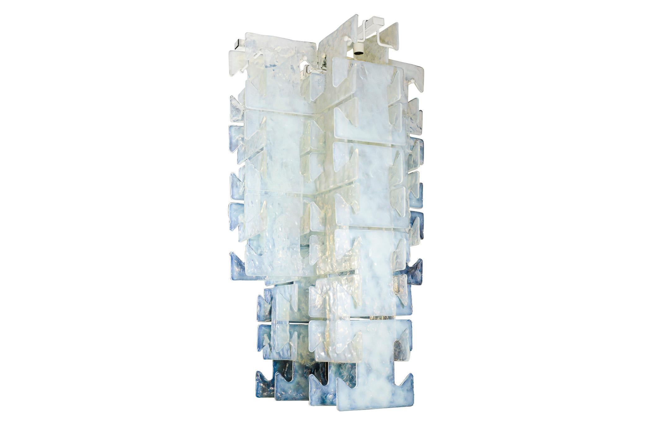 Leucos,
Opalescent light chandelier,
Modular, 48 big opalescent T-shaped pieces of glass,
circa 1970, Italy.

Measures: Height 138 cm, width 80 cm, depth 76 cm.