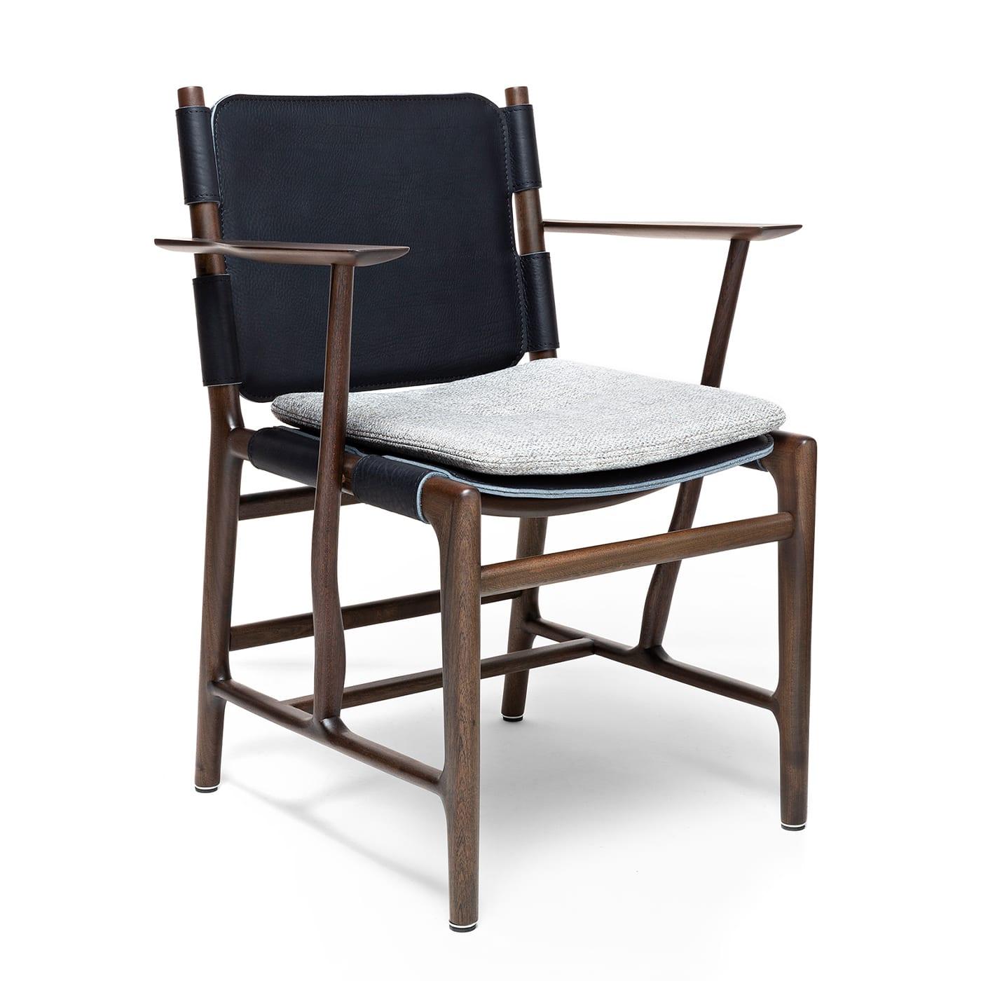 Boasting a clean yet intricate structure fashioned of hand-carved mahogany finished in a Barriquet shade, this extraordinary chair with armrests designed by Massimo Castagna combines minimalist lines and thicknesses to exude utmost lightness.