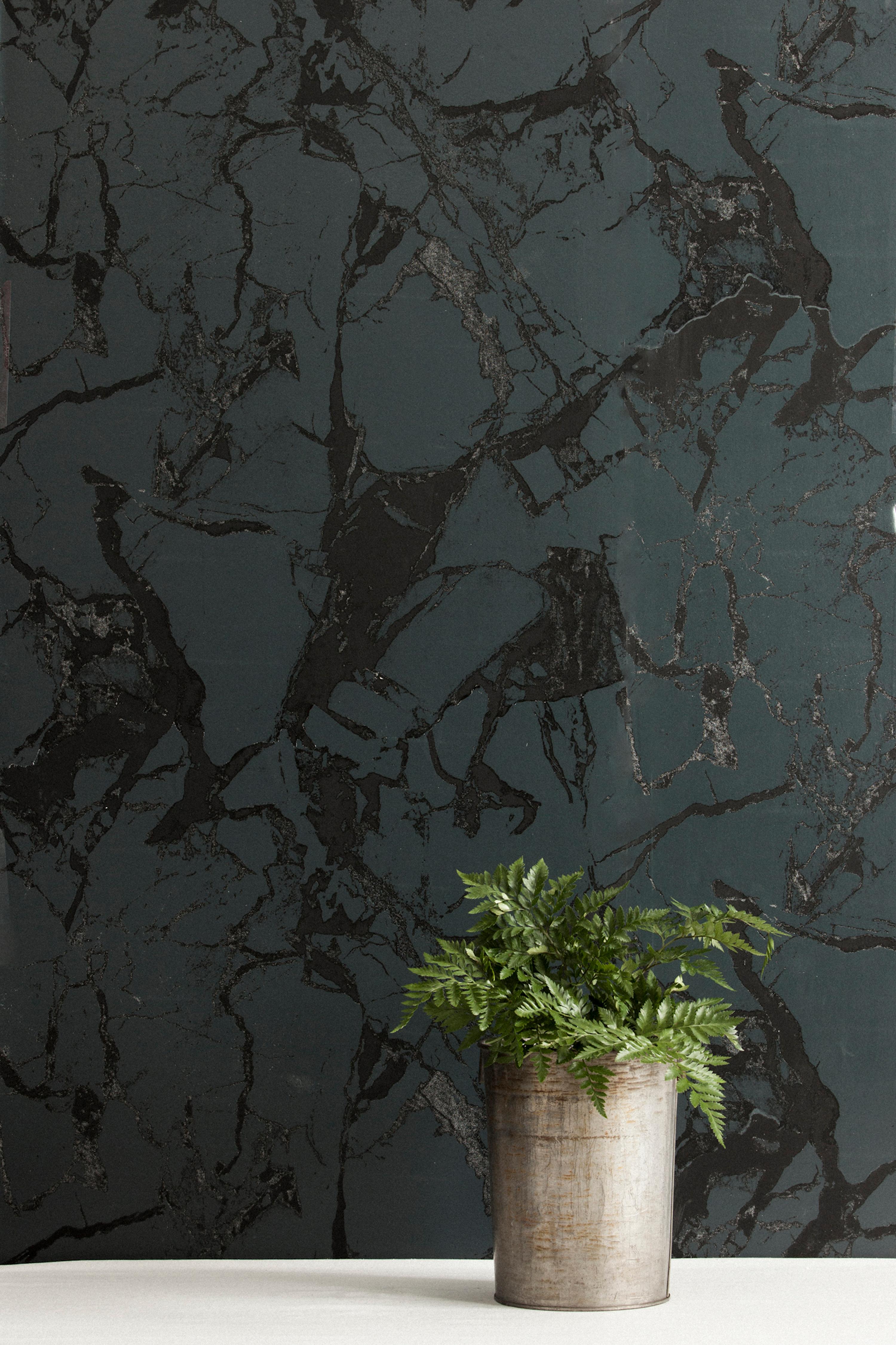 Nero is a luxurious hand printed wallpaper featuring dark gray and subtle black inks that create a tonal marble effect pattern. It is also washable, strippable, unpasted, and class A fire rated. Type II & contract wallpaper is also available. Made