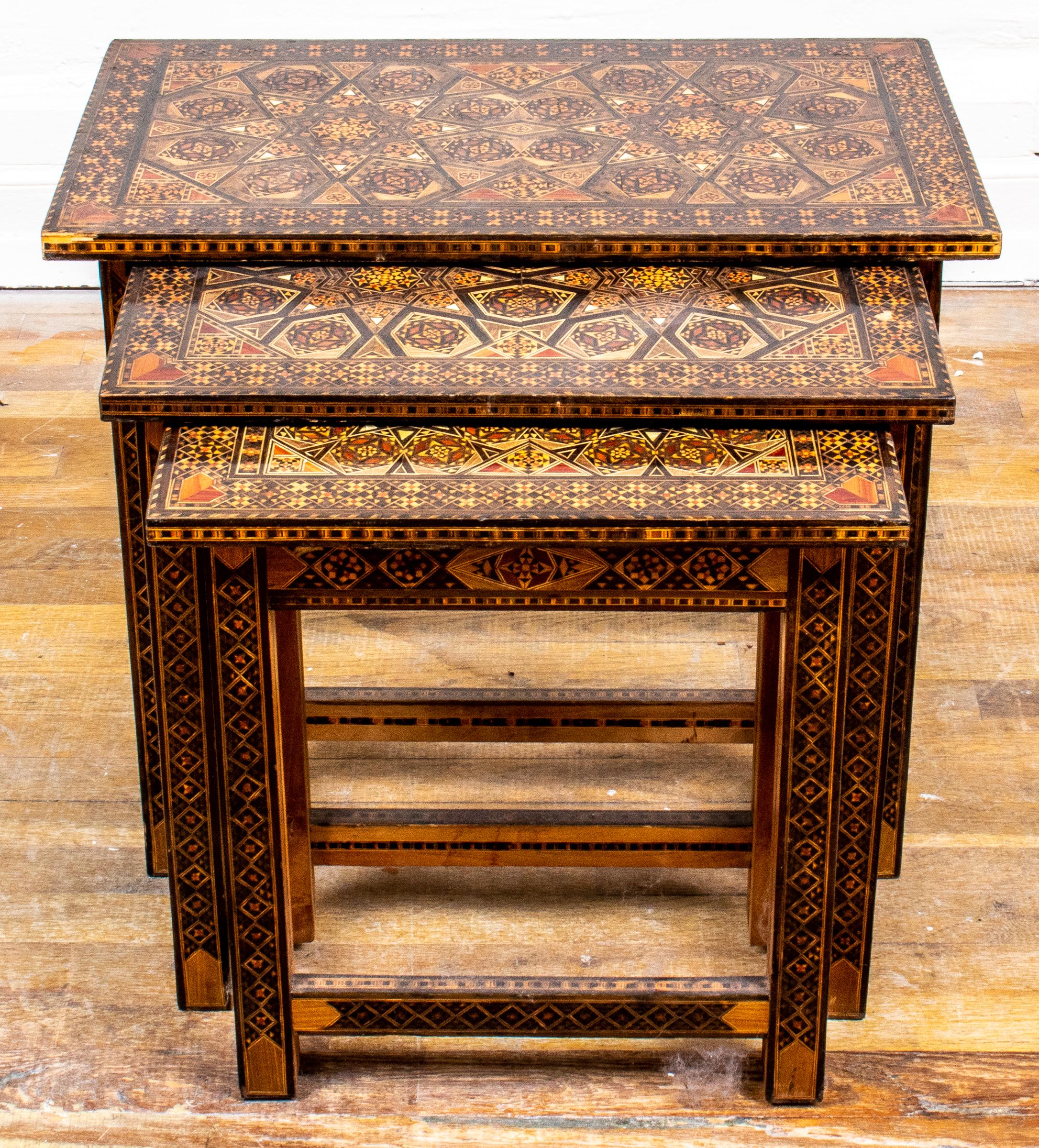 Set of three Levantine graduated and mixed wood inlaid nesting tables. Measures: Largest 20” H x 23.75” W x 14.25” D.