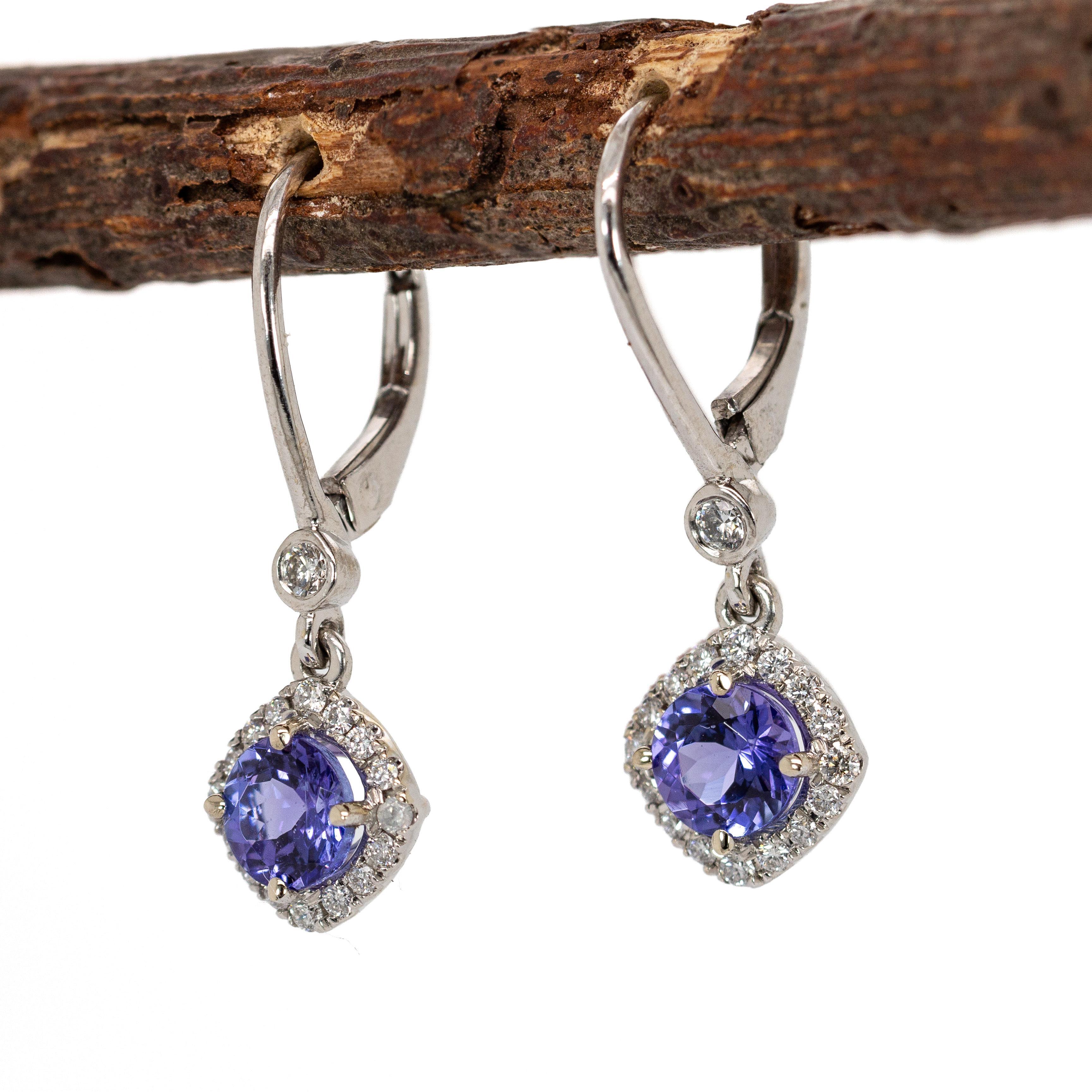 Gorgeous 5mm round tanzanites shimmer inside a diamond halo, crafted in polished 14K white gold. Lever backs make them easy to wear—because luxury should never be complicated.

