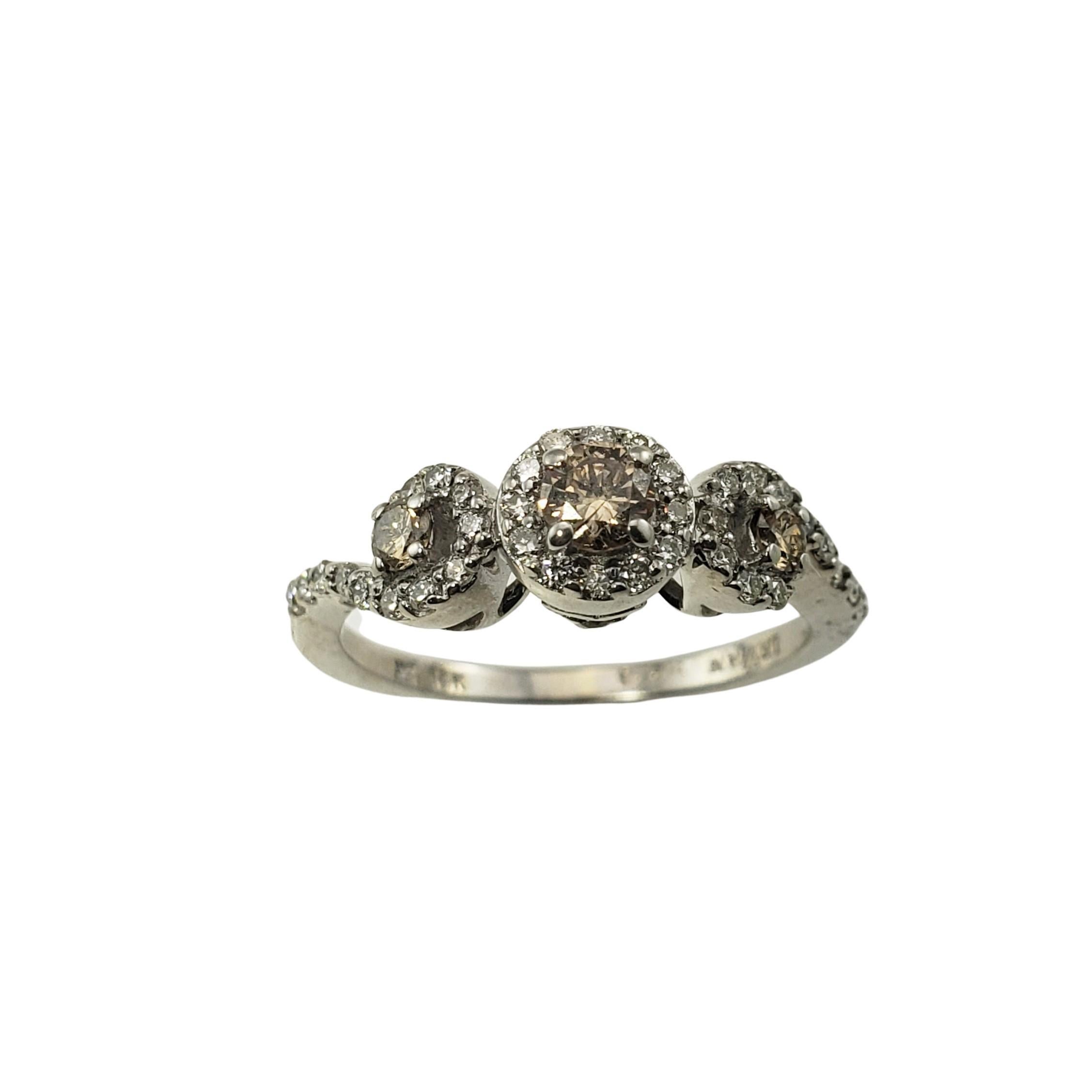 Vintage LeVain 14 Karat White Gold Champagne and White Diamond Ring Size 5.5-

This sparkling ring features five round brilliant cut champagne diamonds (.23 total carat weight) and 26 round brilliant cut white diamonds (.36 total carat weight) set