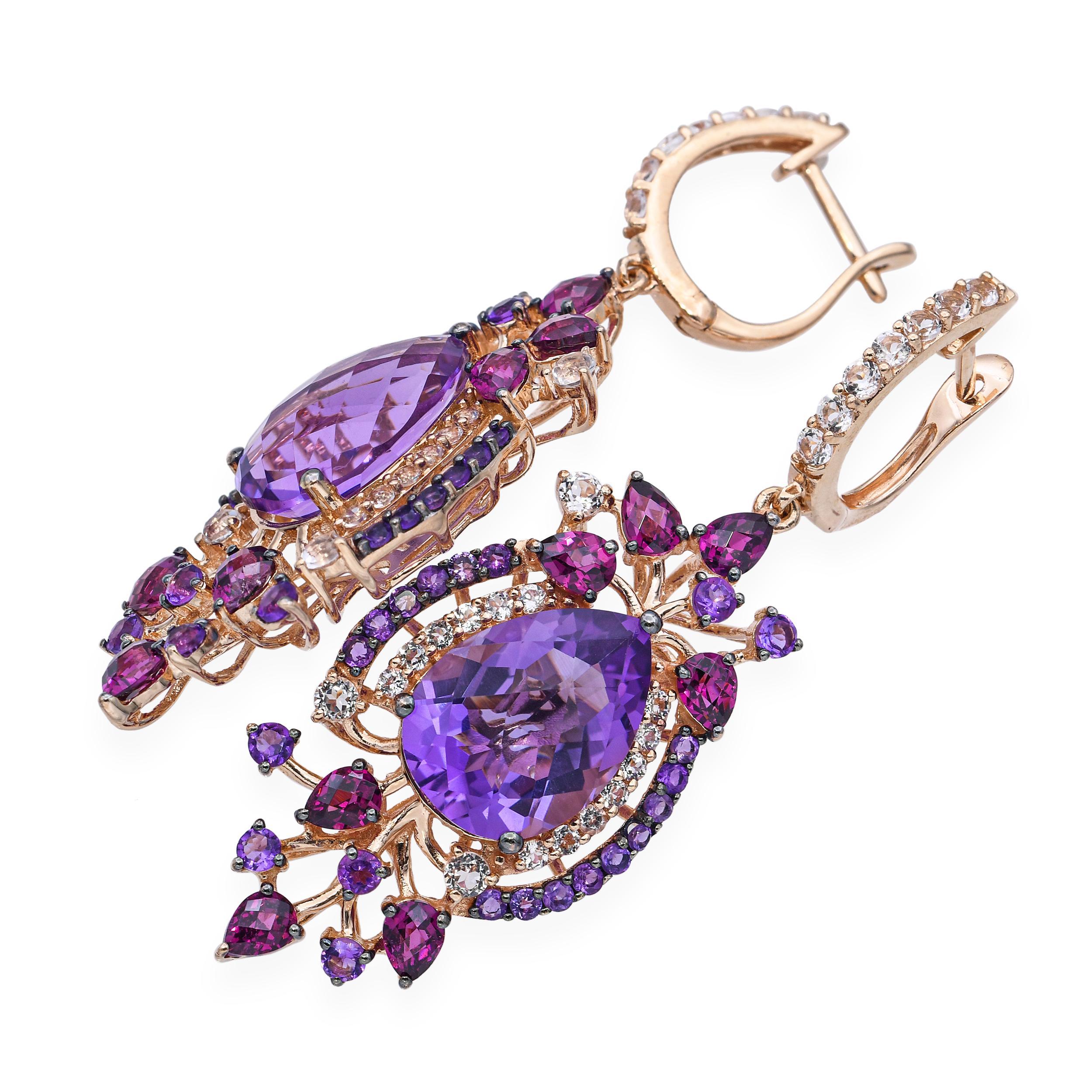 These stunning LeVian rose gold earrings feature a rich amethyst centerstone, elegantly framed in a floral bouquet-inspired design. Surrounding the center are delicate clusters of garnet, additional amethyst, and shimmering white topaz accents,