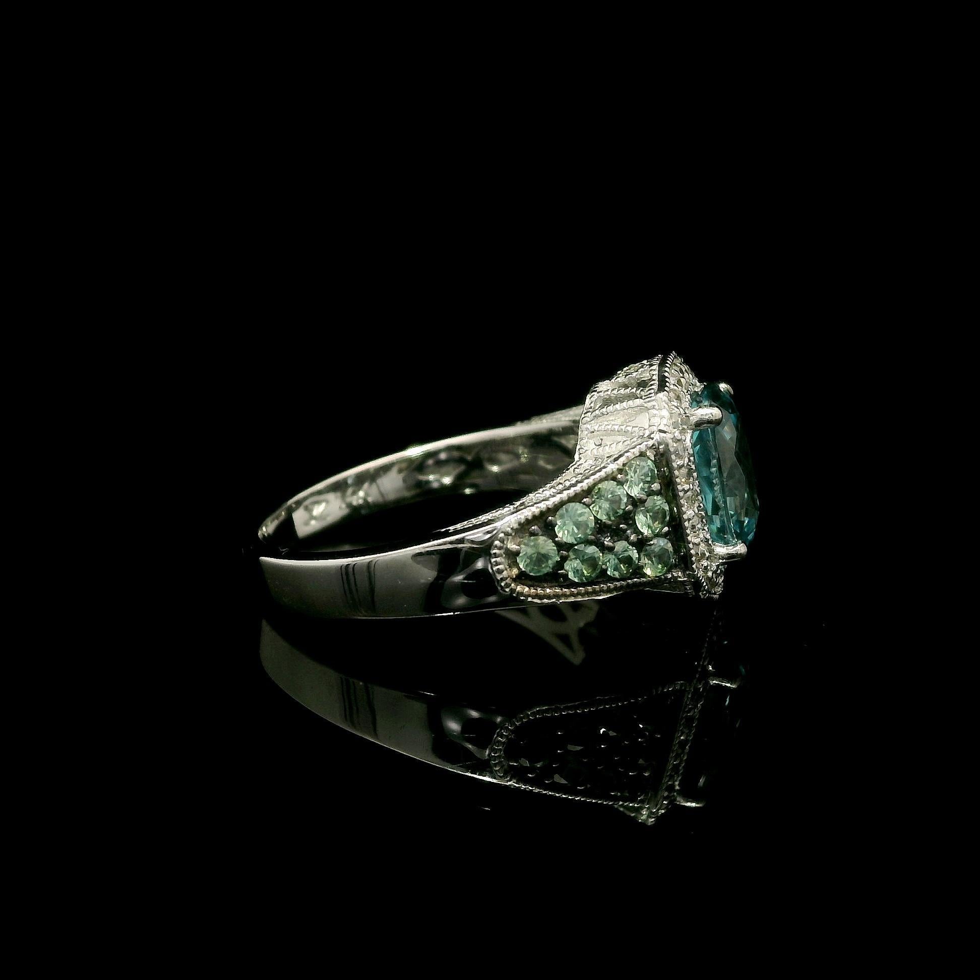 -- Stone(s) --
(1) Natural Genuine Zircon - Oval Brilliant Cut - Prong Set - Vivid Blue Color - 8.0 x 5.8mm (approx.) 
(16) Natural Genuine Alexandrite - Round Brilliant Cut - Pave Set - Minty Green Color - 1.61mm (approx.)
(26) Natural Genuine