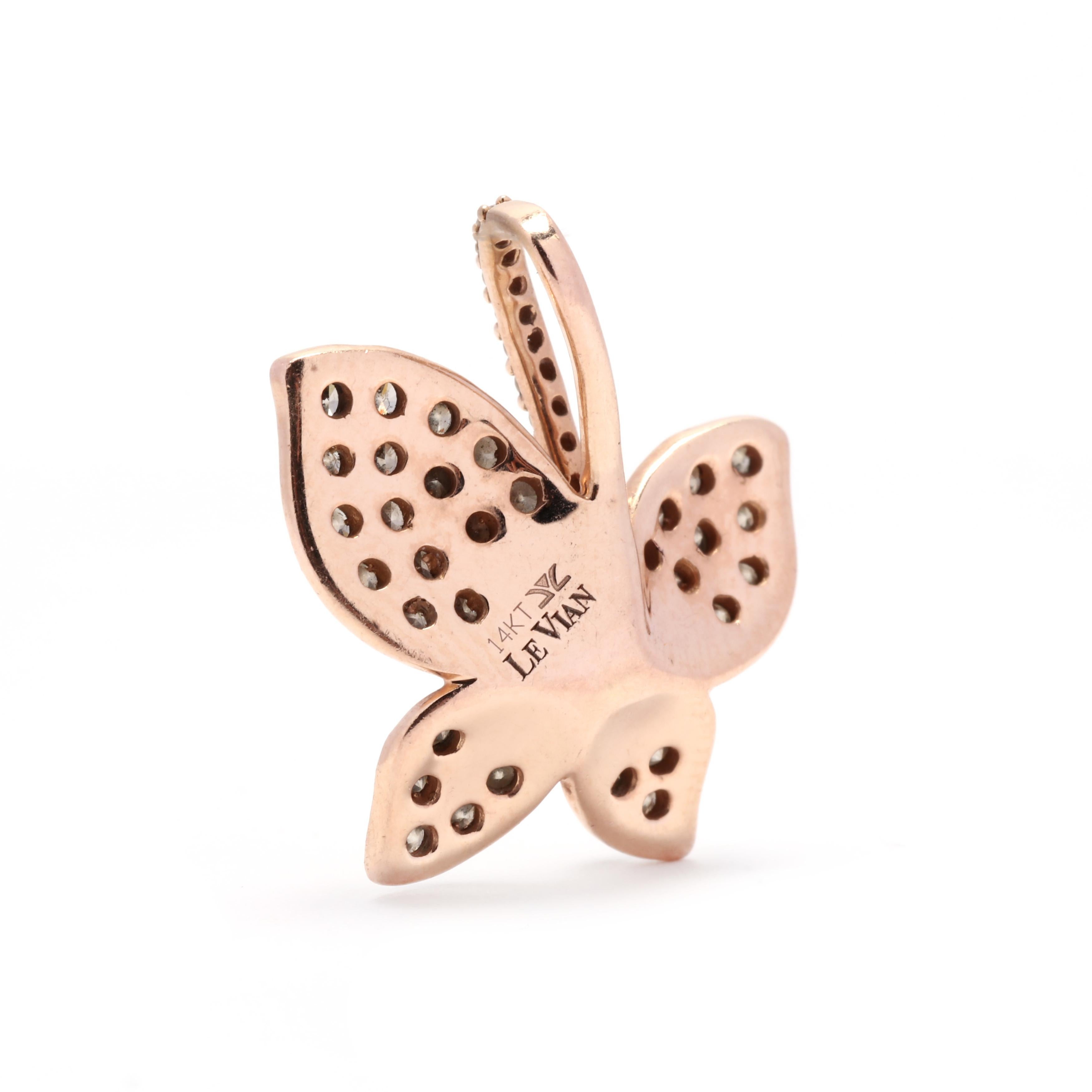 A 14 karat rose gold chocolate and white diamond butterfly pendant by LeVian. This pendant features a three dimensional butterfly motif set with white diamonds in the center weighing approximately .16 total carats and surrounded by chocolate