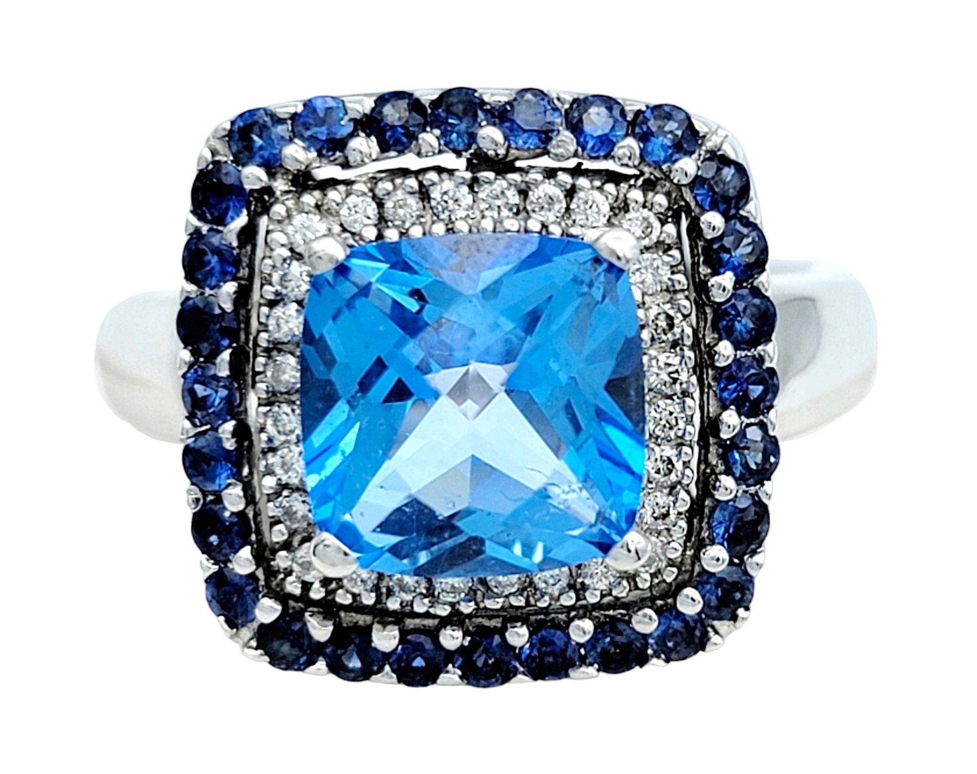 Ring size: 6.75 

This gorgeous Le Vian cocktail ring, set in lustrous 14 karat white gold, is a mesmerizing symphony of color and brilliance. At its heart is a breathtaking 3.06 carat cushion-cut blue topaz. The topaz's vivid azure hue is