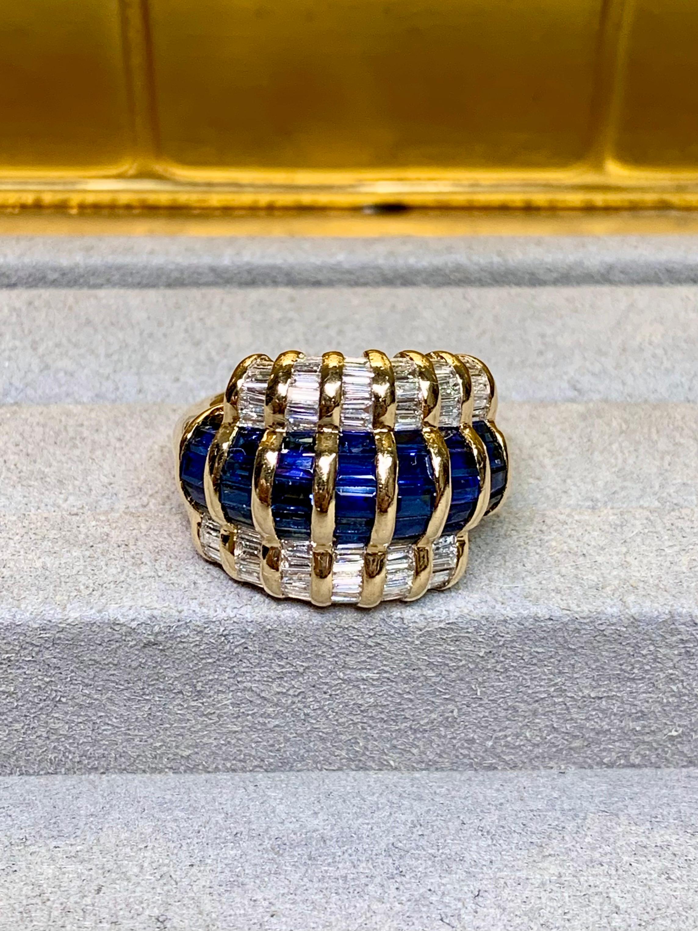 A classic bypass style cocktail ring crafted in 18K yellow gold by Le Vian. It has been channel set with approximately 1.30ctw in G-I color Vs-Si clarity baguette diamonds as well as 2.40ctw in natural baguette cut blue