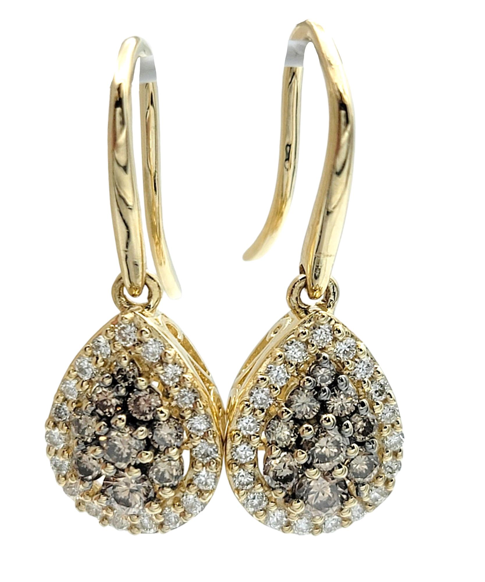 These Le Vian earrings, set in luxurious 14 karat yellow gold, are a true embodiment of elegance and sophistication. The focal point of each earring features a cluster of chocolate diamonds arranged in a pear-shaped formation, adding a rich and