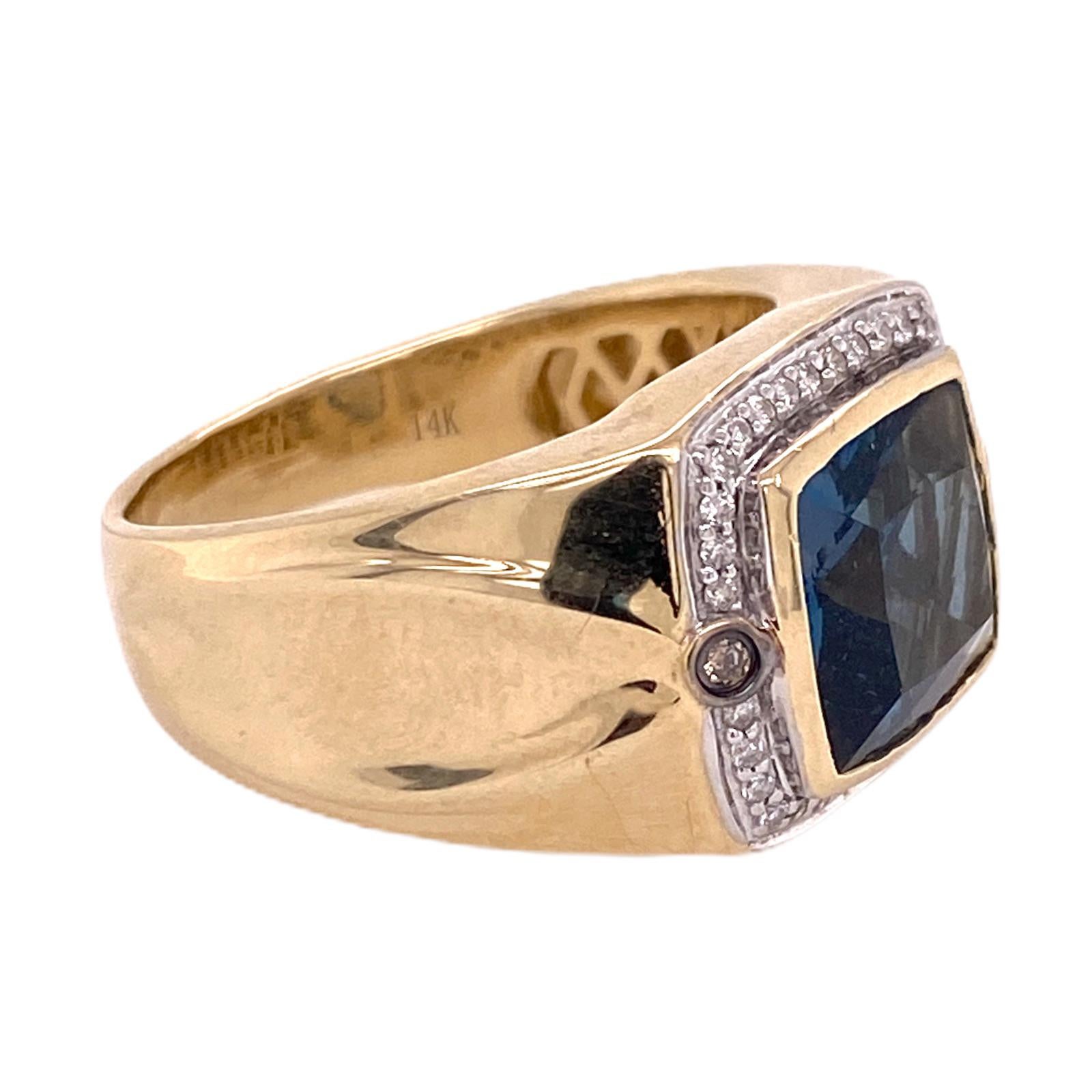 Fabulous Levian Men's ring fashioned in 14 karat yellow gold. The ring features a 4 carat cushion cut London Blue Topaz. The topaz is surrounded by 36 round brilliant cut diamonds (white and chocolate) weighing .25 carat total weight. The ring