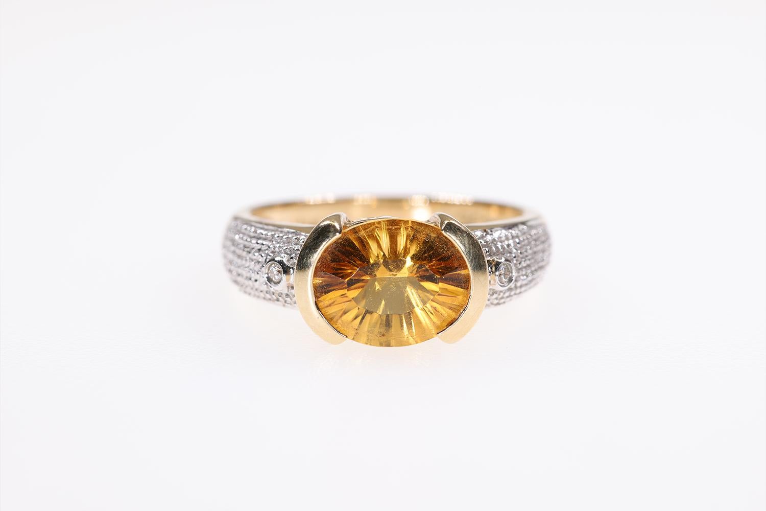 This is a beautiful LeVian Oval Citrine Fashion ring made of 14K Yellow and 14K White Gold. It is accented by two small diamonds. The center stone is a Citrine of nice deep color.
