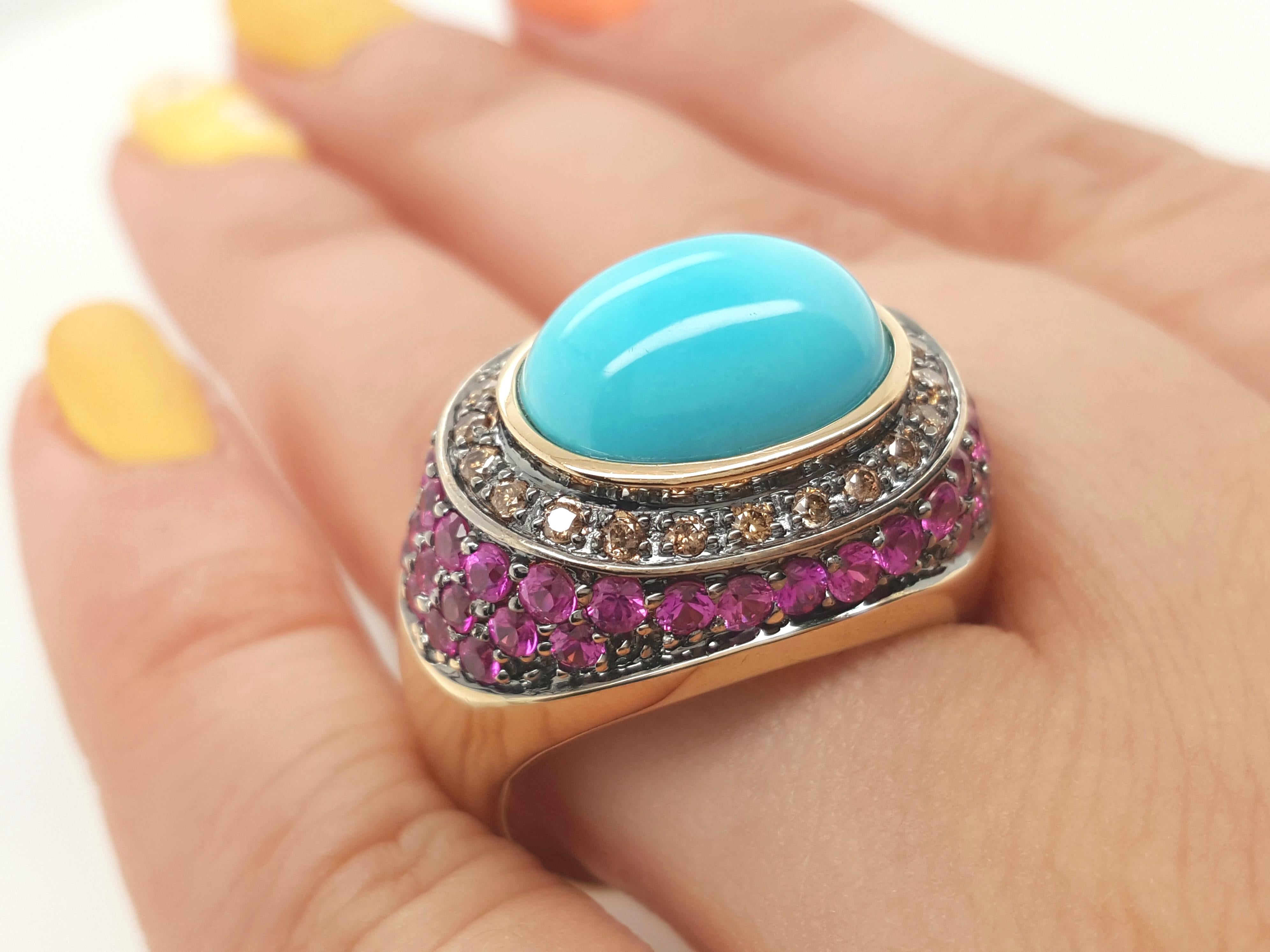 LeVian 14 Karat yellow gold ring includes a beautiful bright Egg Blue Turquoise cabochon center. The turquoise center is bezel set in a yellow gold frame that is complemented with chocolate diamonds and rubies. A gorgeous piece in great condition