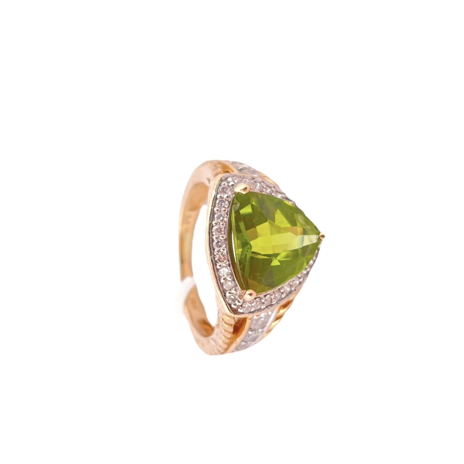 Step into a world of glamour and elegance with this exquisite LeVian Trillion Peridot Ring, adorned with 0.60 total carat weight (TCW) of diamond accents. 
Crafted in opulent 14K yellow gold and weighing 5.58 grams, this ring is a true masterpiece