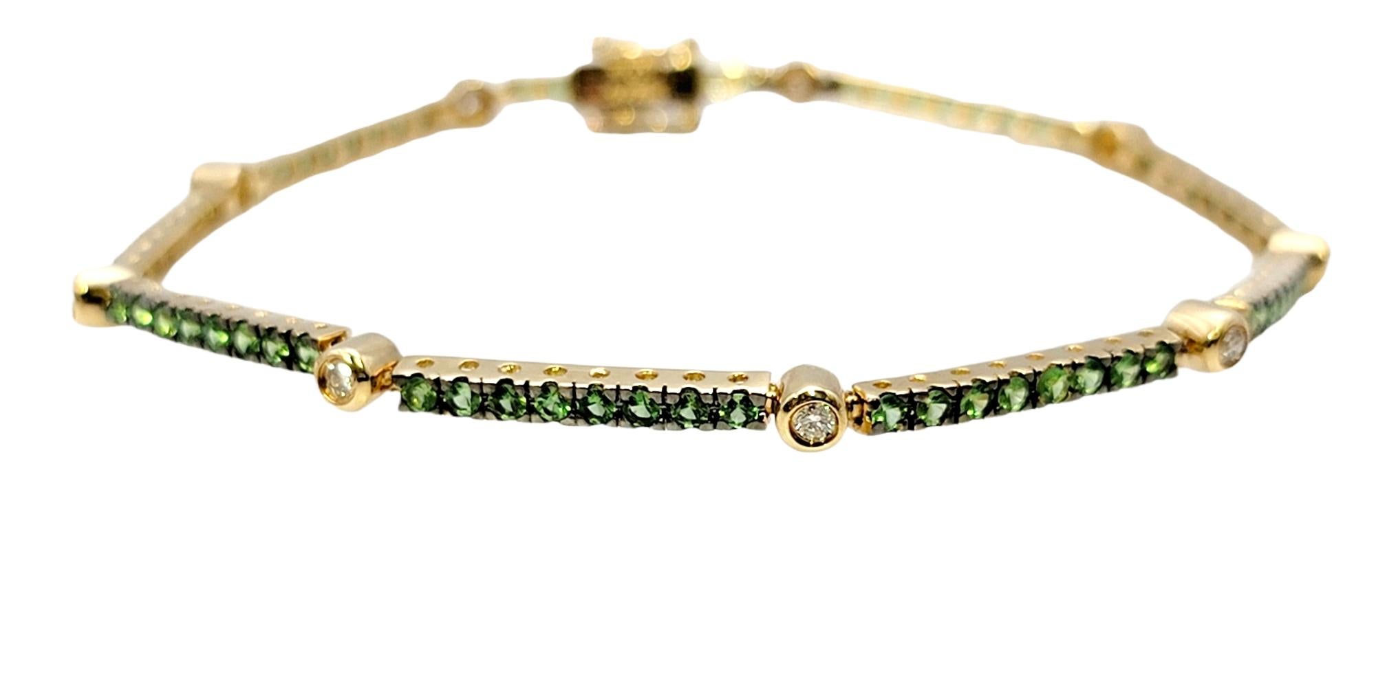 Bright and colorful tsavorite garnet and diamond station tennis bracelet. This lovely, sparkling piece adds a subtle pop of color to the wrist, while remaining delicate and feminine. Would look gorgeous stacked with other bracelets or simply worn on