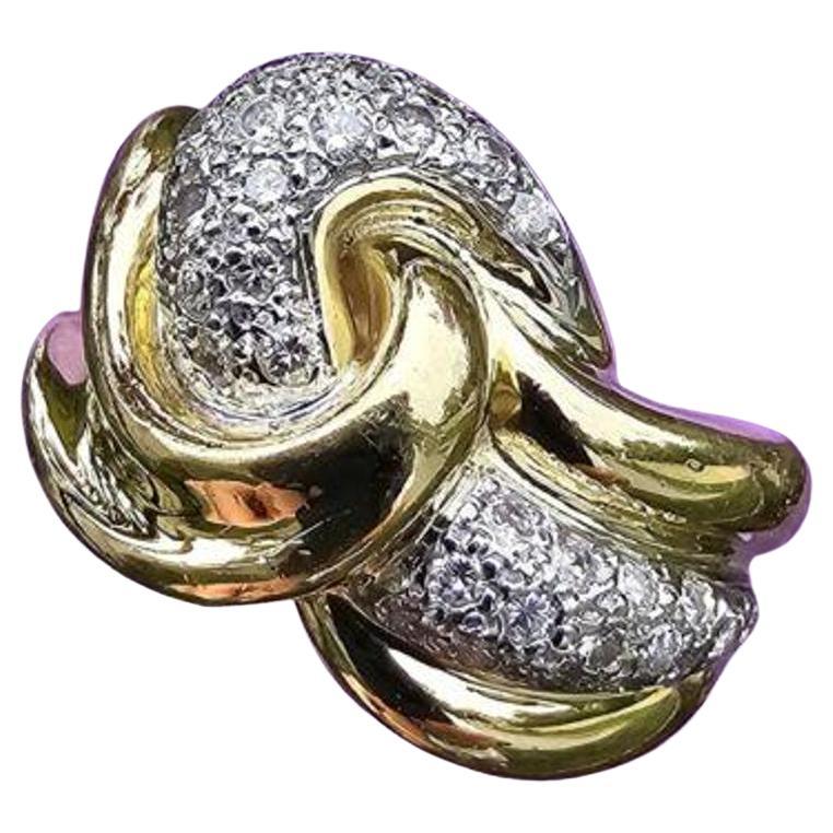 This stunning ring from Le Vian features a unique twist knot design in 18k yellow gold, with a crossover bypass style that adds flair and elegance. The main stone is a sparkling diamonds, adding to the beauty and sophistication of the piece.