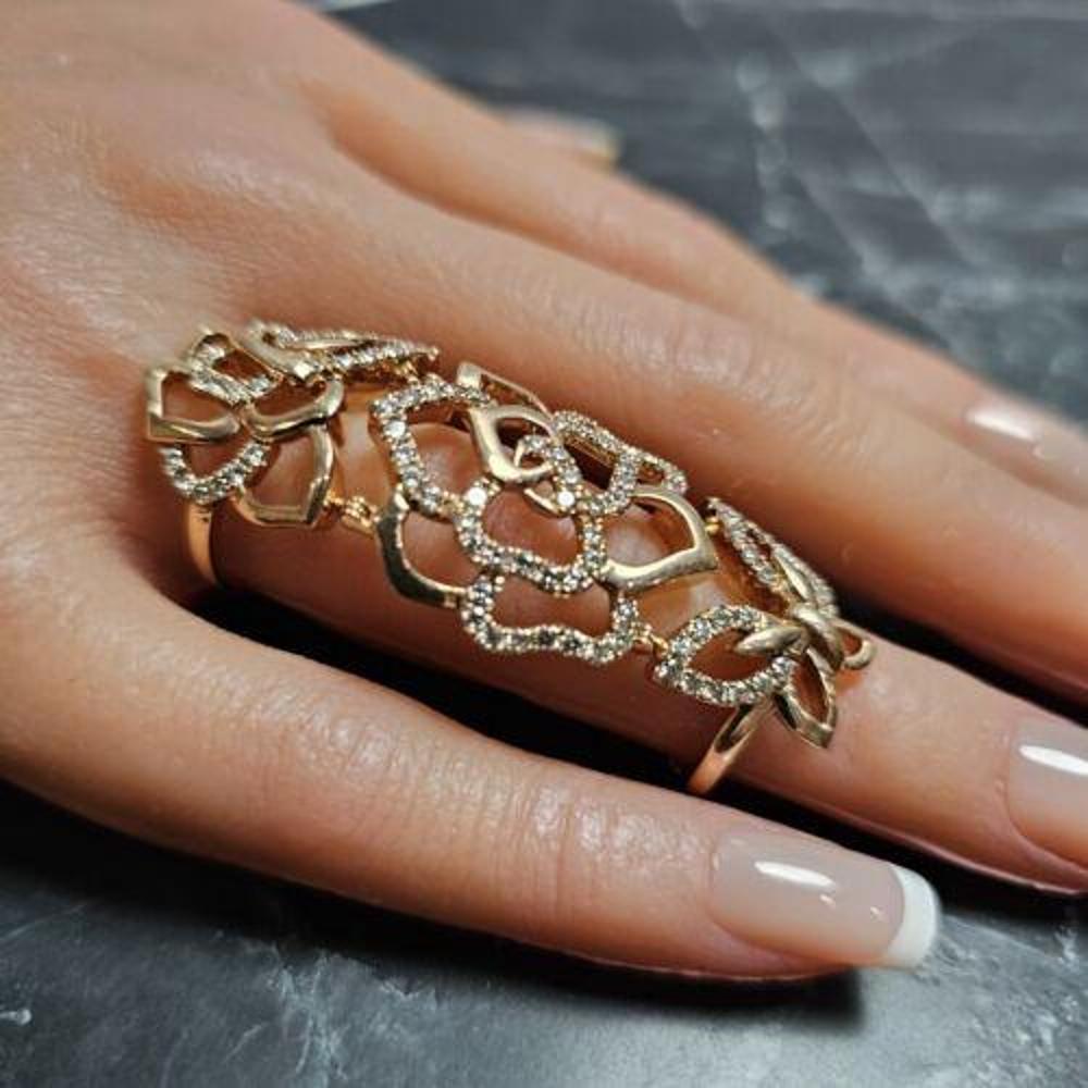 This Le Vian ring is crafted in 14k rose gold and features a unique design with diamond-encrusted flowers and a butterfly motif. The main stone is a stunning diamond, adding elegance and sparkle to the piece. The ring is a whole finger style, with
