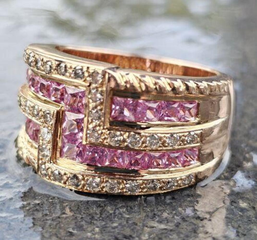 This stunning Levian wide band ring features dazzling pink sapphire princess cut stones set in 14k rose gold. The band is adorned with additional sparkling round diamonds, adding to its royal elegance. The ring is a size 7 and is perfect for any