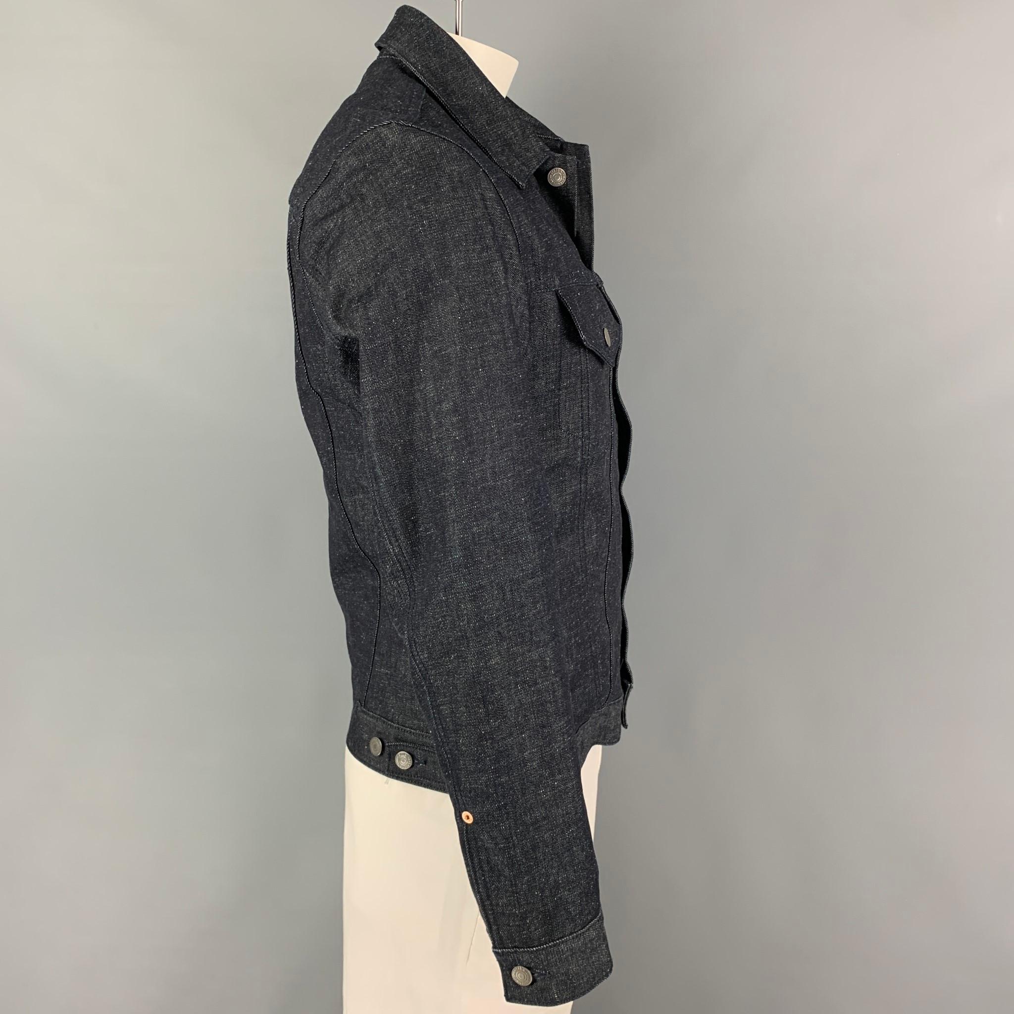 LEVI'S jacket comes in a blue indigo denim with a wool stripe interior featuring a trucker style, pointed collar, patch pockets, and a buttoned closure. 

Excellent Pre-Owned Condition.
Marked: M

Measurements:

Shoulder: 18 in.
Chest: 38