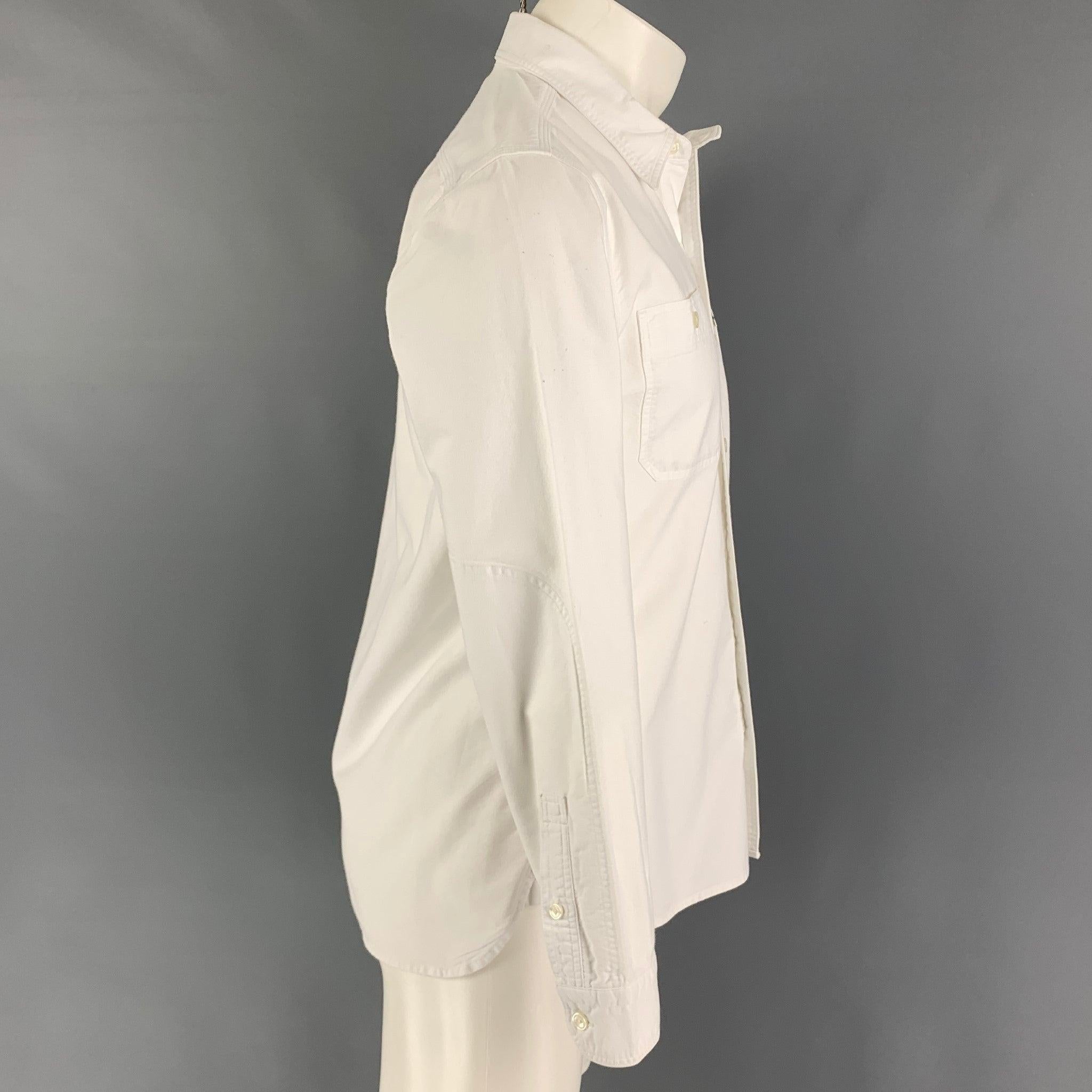 LEVI'S long sleeve shirt comes in a white cotton featuring a spread cotton, patch pockets, and a button up closure.
Good Pre-Owned Condition. Light marks at back. As-is. 

Marked:   M  

Measurements: 
 
Shoulder: 17 inches Chest: 40 inches Sleeve: