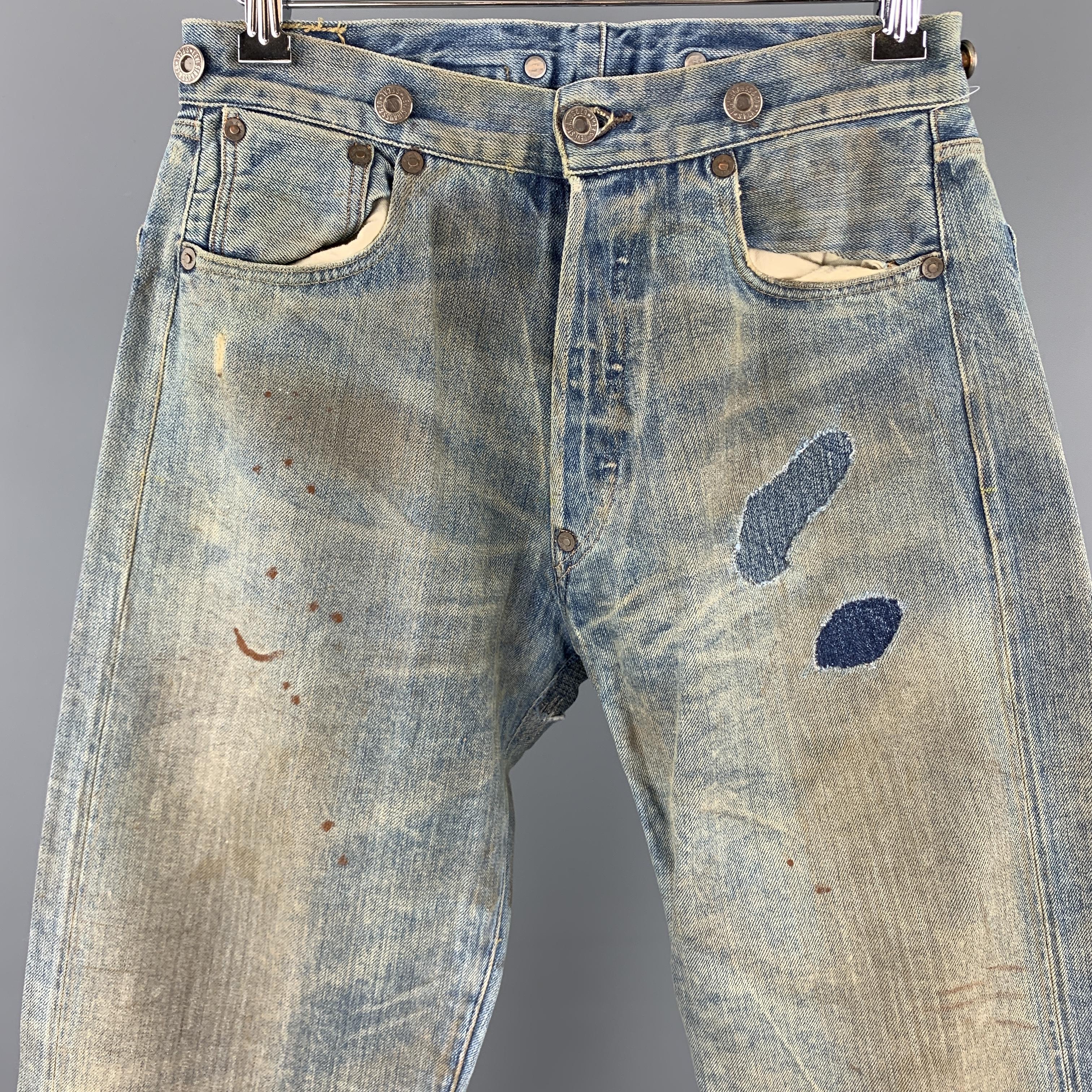 LEVI'S sample jeans come in dirty wash selvedge denim with distressing details throughout, button fly, patchwork, and brace button waistband. Made in USA.

Excellent Pre-Owned Condition.
Marked: (no size)

Measurements:

Waist: 27 in.
Rise: 11.5