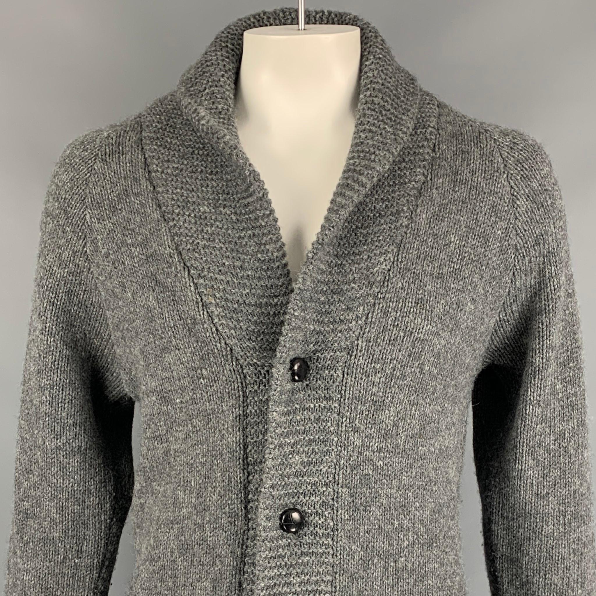 LEVIS VINTAGE CLOTHING cardigan comes in a dark gray & black knitted wool featuring a shawl collar, patch pockets, and a buttoned closure. 

Very Good Pre-Owned Condition.
Marked: S

Measurements:

Shoulder: 16.5 in.
Chest: 40 in.
Sleeve: 30