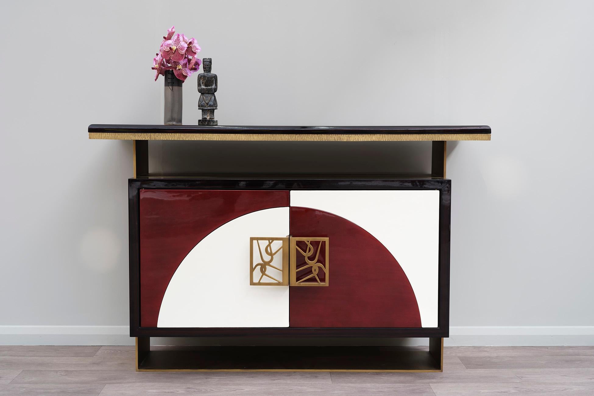 Contemporary Handcrafted Cabinet mixing Asian and Art Deco references, in Lacquer and Brass.

Levitation cabinet is a balancing feature; its support frame is laser cut in solid brass. The case and top are in dark gloss ebony veneer, the interior in
