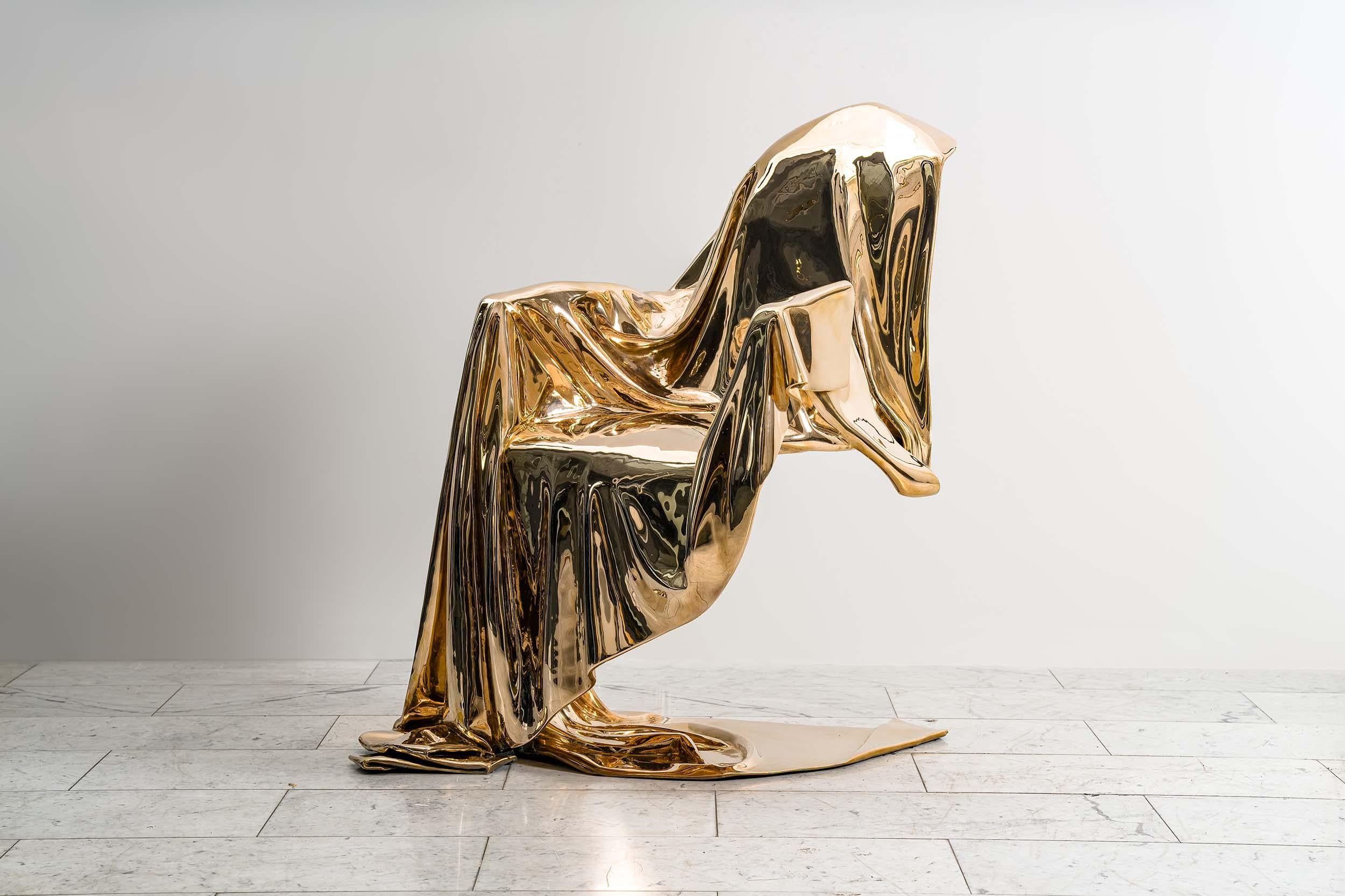 In this remarkable armchair, a masterwork of artistic ingenuity and technical virtuosity, we bear witness to an exquisite fusion of form, materiality, and conceptual depth. Crafted entirely from cast bronze, its mirror polish finish evokes an