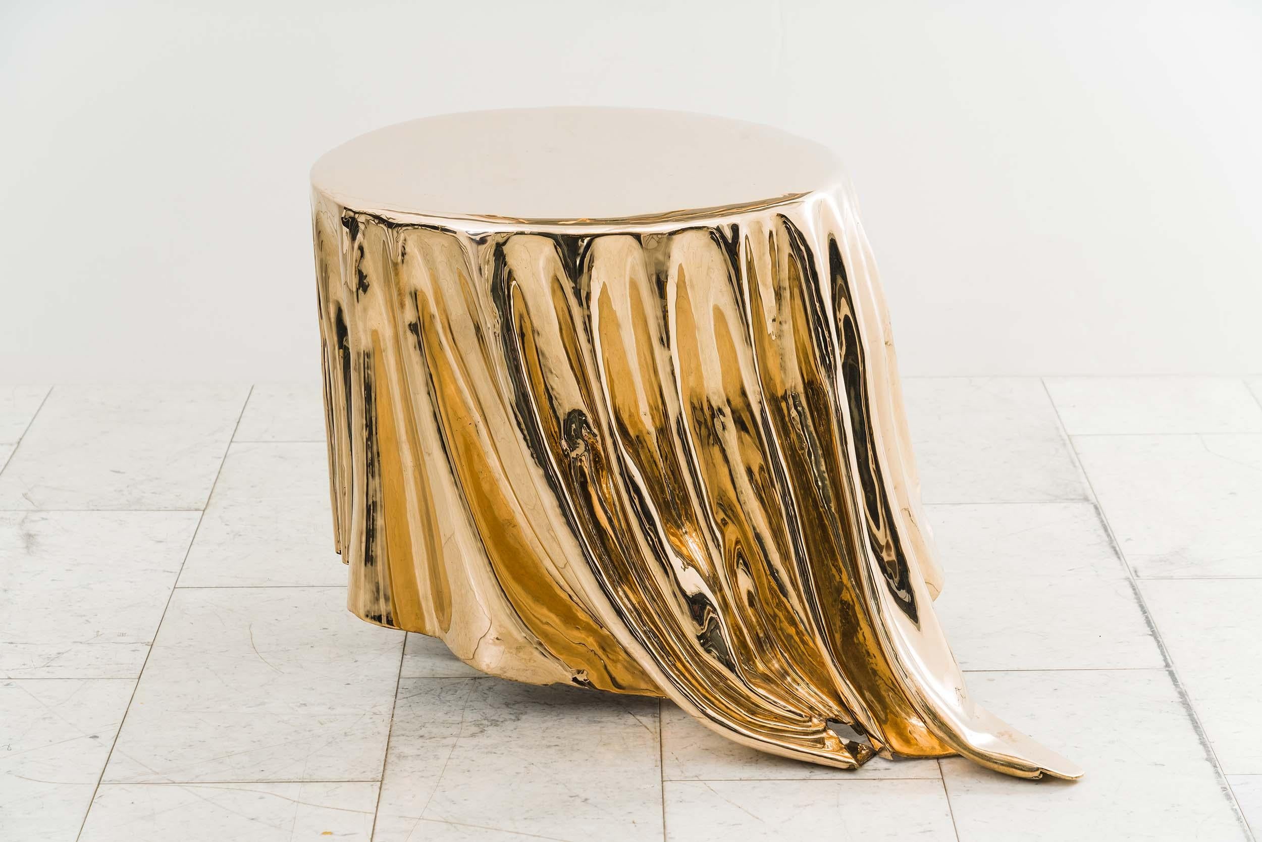 The Levitaz Side Table in cast bronze is a sculptural masterpiece that manifests fluidity and motion in a solid form. Through exquisite craftsmanship, bronze is transformed into a cascade of fluid lines, reminiscent of draped fabric frozen in time.