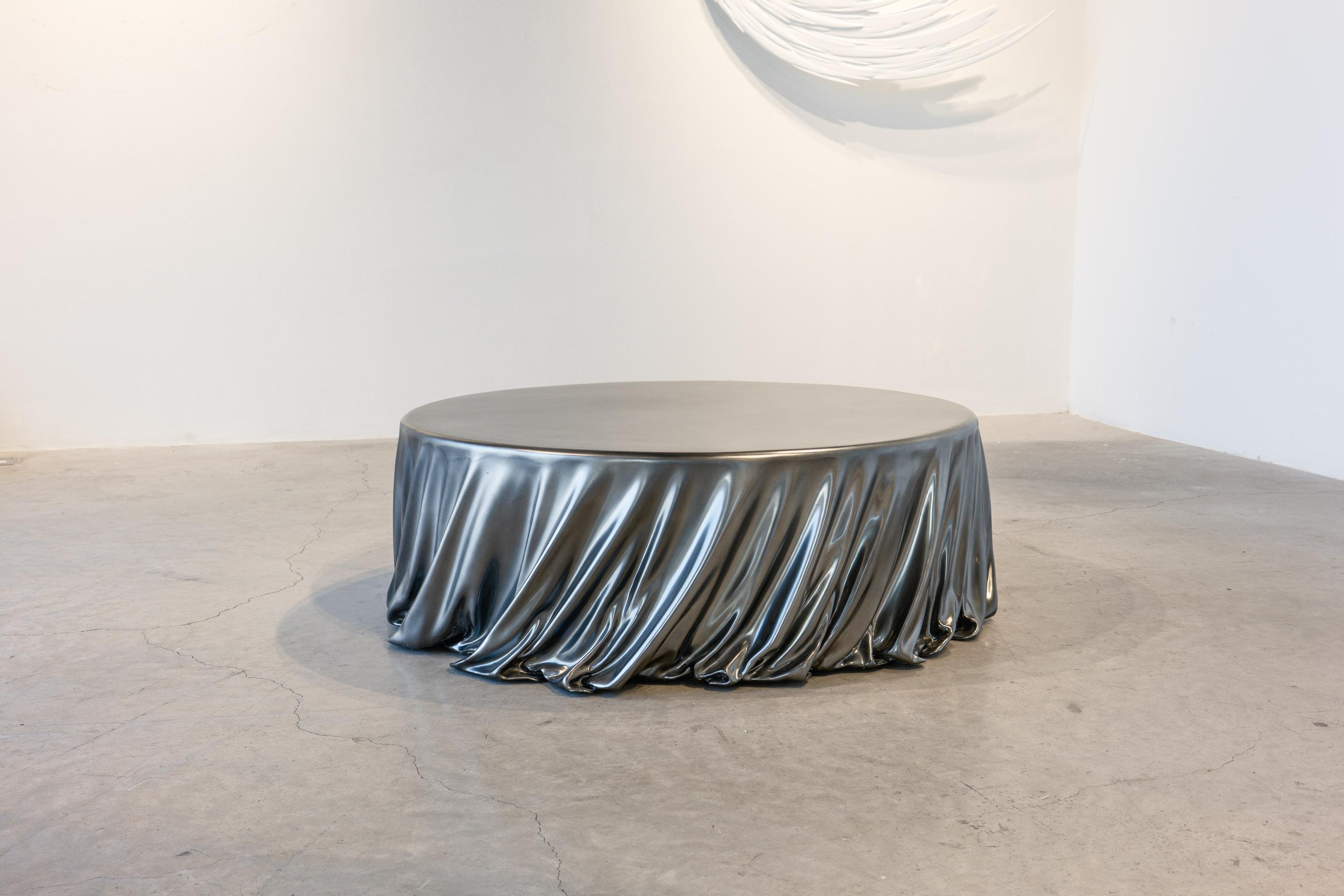 The Levitaz Round Coffee Table, finished in our proprietary Velvet Chrome, exemplifies modern sophistication with its elegant design and meticulous craftsmanship. This piece, sculpted from high-strength resin reinforced with carbon fiber, achieves a