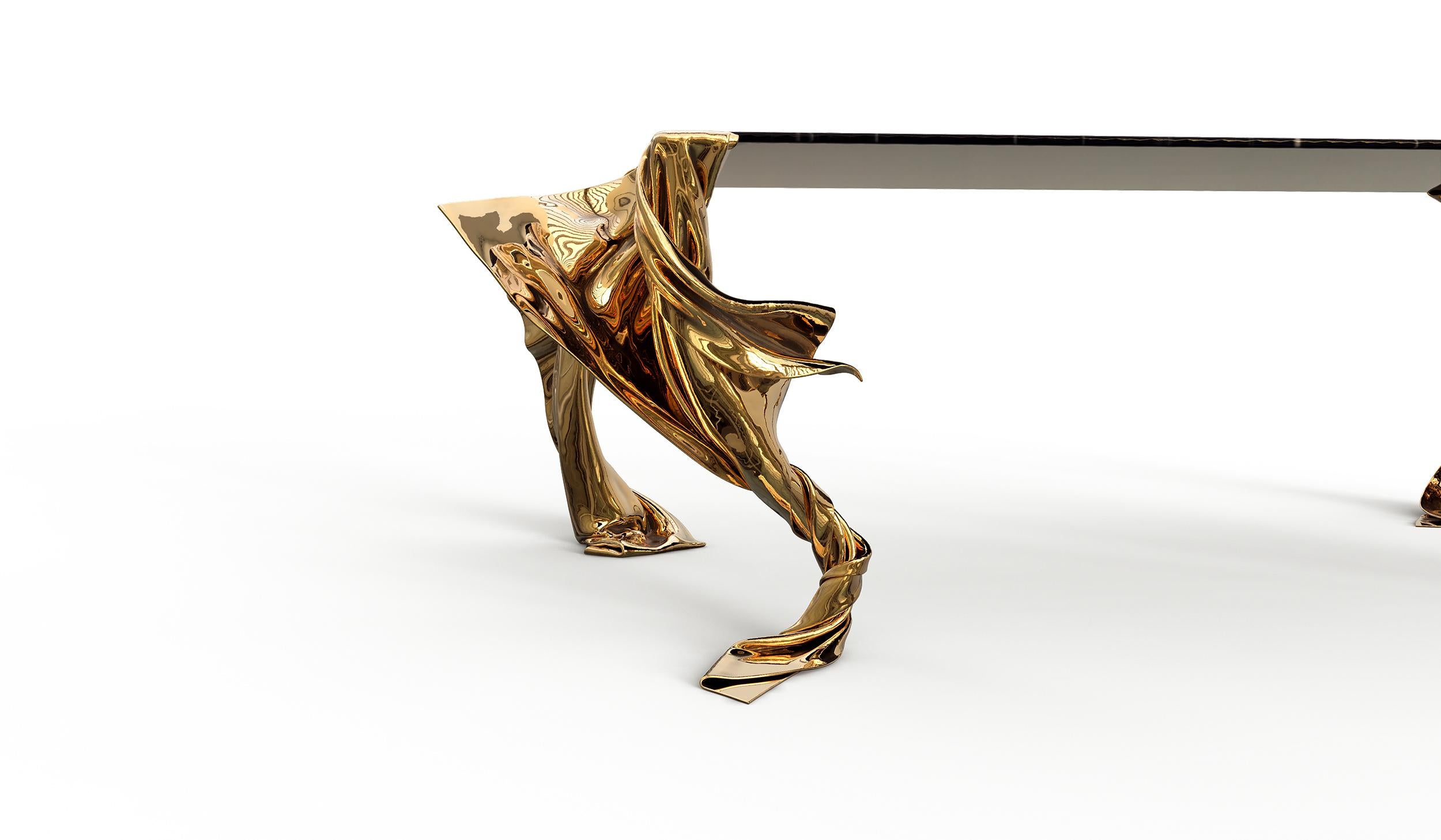 The Volante Dining Table, a distinguished piece from the Levitaz Collection, artfully combines the timeless elegance of marble with the sculptural beauty of cast bronze. The table's legs are a testament to fluid design, as bronze is transformed to