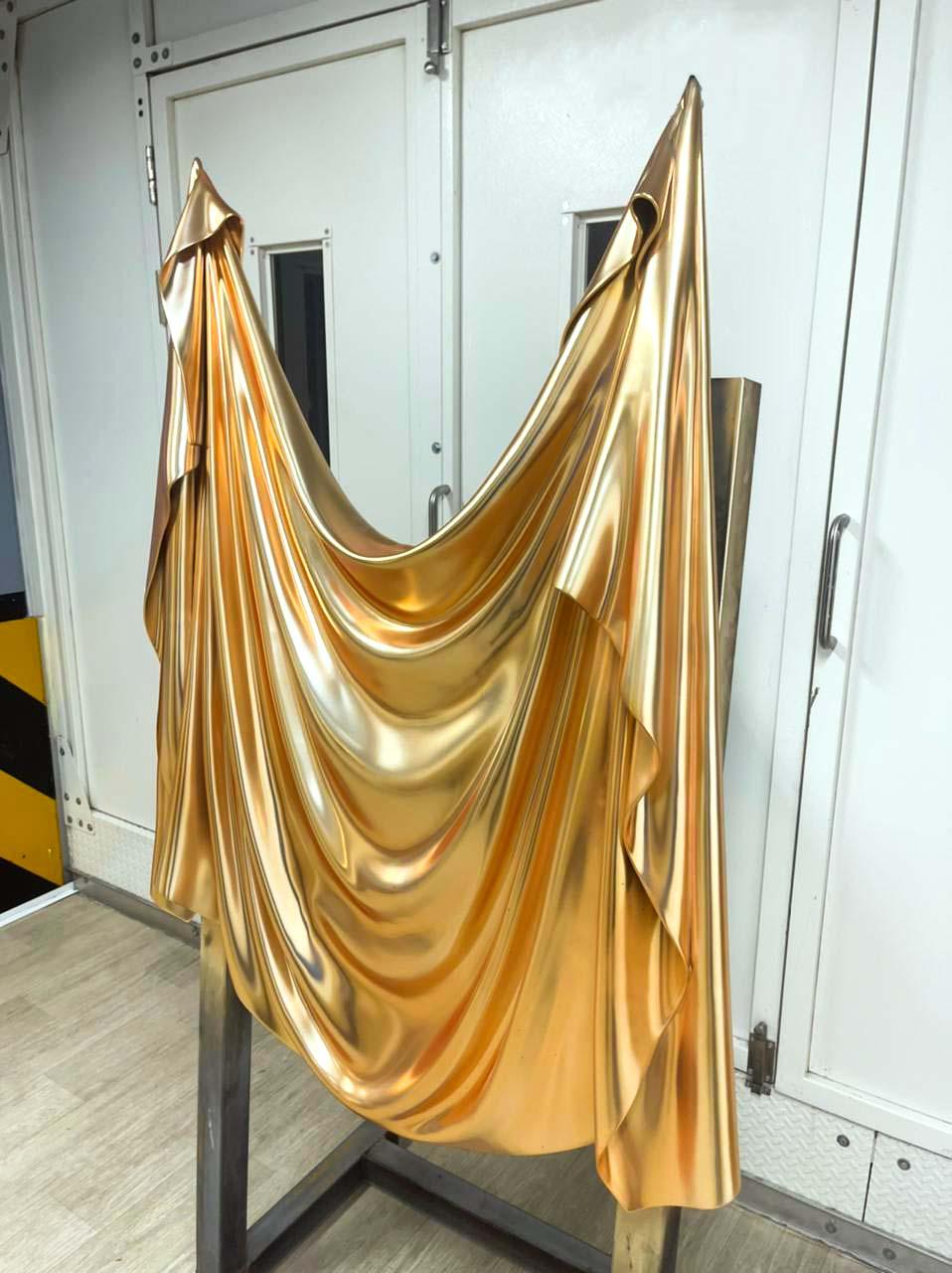 The Levitaz Wall Panel II, cloaked in a satin gold finish, materializes as a sculptural enigma that transcends the conventional confines of wall art. This piece, a distillation of motion and stasis, reflects the studio's mastery in capturing